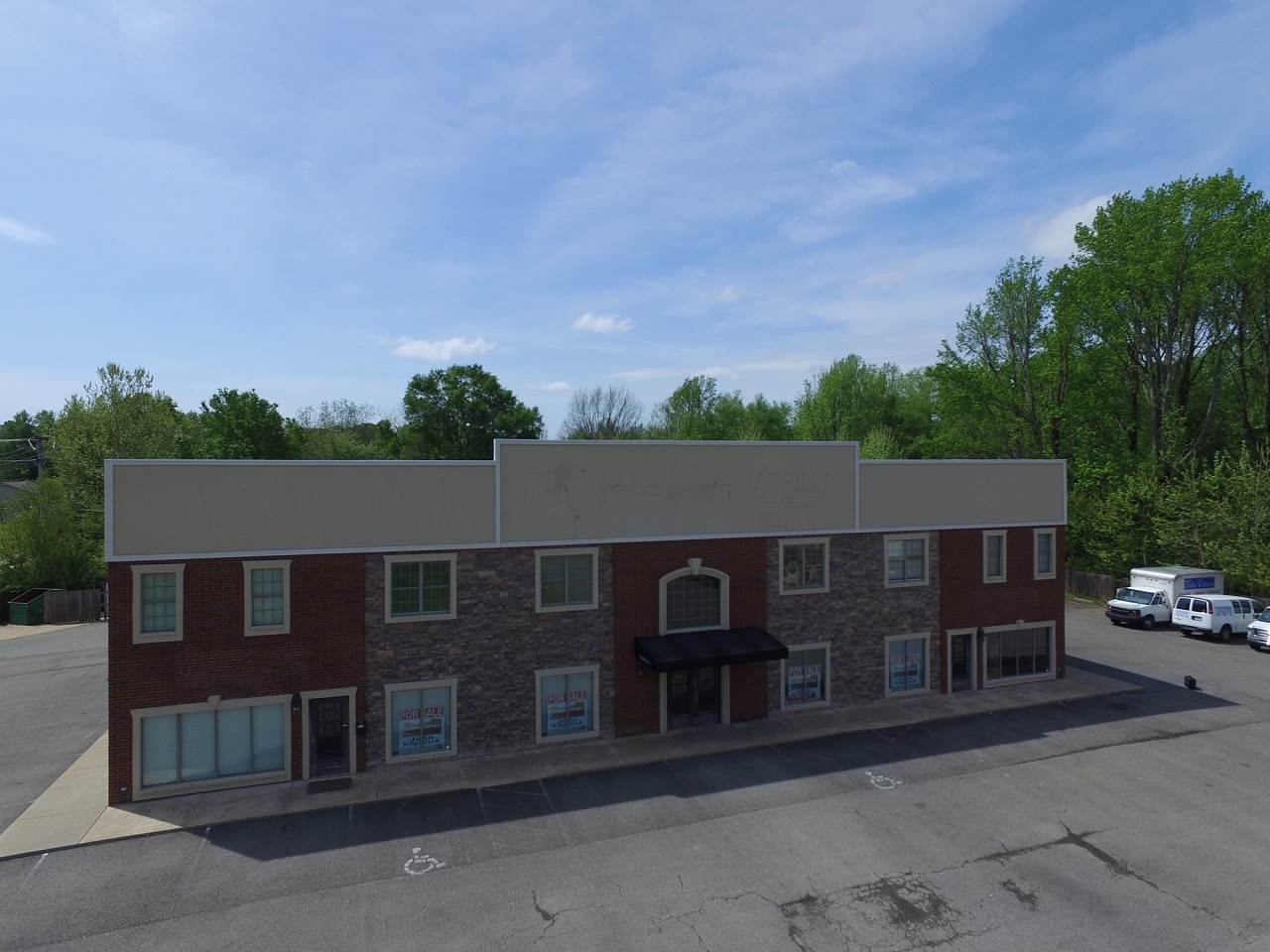 Great location, over 10,000 sqft office building, 5000 downstairs and 5 apartments upstairs *these could be converted into office space if necessary*, plenty of parking and priced to sell below appraisal. Call now for a personal tour.