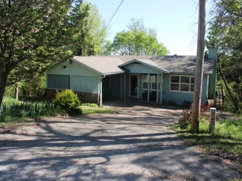 MOTIVATED SELLER! BRING AN OFFER!! This home has one of the best views in the village! You will feel like the Swiss Family Robinson living amongst the trees! Imagine waking up everyday to a gorgeous bluff view of the South Fork River! The home itself will also be a joy to live in! 4 bedrooms, 2 full bathrooms featuring a sunken den with stone fireplace, dining room, large heated and cooled sunroom, 3 bedrooms 1 bath on the main level and 1 large bedroom, bath, & laundry in the walk out basement. 3 decks, carport, newer HVAC & water heater, and cove lot make up a few more awesome qualities that make this home "the one". Call your favorite Realtor today for a showing!