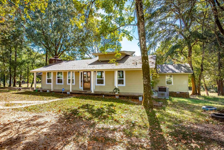 MORRILTON ACREAGE OASIS! Rare 3 Bed, 3 Bath home with two living areas on 3.20 acres inside city limits, offering a true country feel. Enjoy mature shade trees and backyard wildlife. Features include a large sunroom/den with wood burning stove, and an expansive covered back deck—perfect for year-round entertaining. UNIQUE KITCHEN! This unforgettable kitchen has tons of character. The rest of this solid home is a design-ready canvas priced for you to add immediate value and define every space with your own custom taste and flair. City convenience meets rural tranquility! Contact agent for showing.
