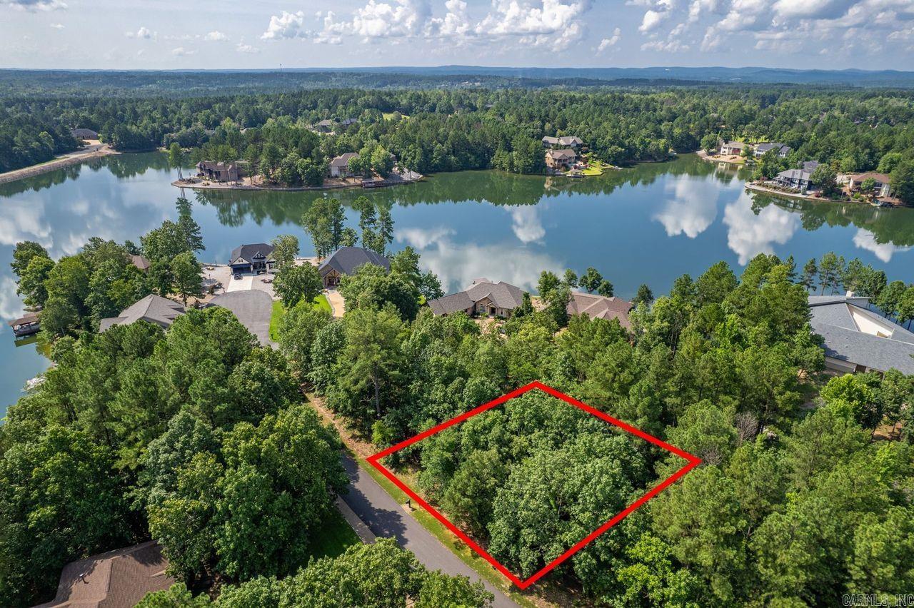 Take advantage of this fantastic opportunity to build in this desirable subdivision with a seasonal view of Lake Granada! Lot 20 offers a peaceful, wooded setting near the cul-de-sac, just a short drive from Granada Golf Course and lake amenities like fishing, boating, and walking trails. Ideal for a custom home or investment property, this gently sloped lot provides privacy, elevation, and access to Hot Springs Village’s vast amenities. Lot 20 and 22 are both available—buy one or both for added privacy!