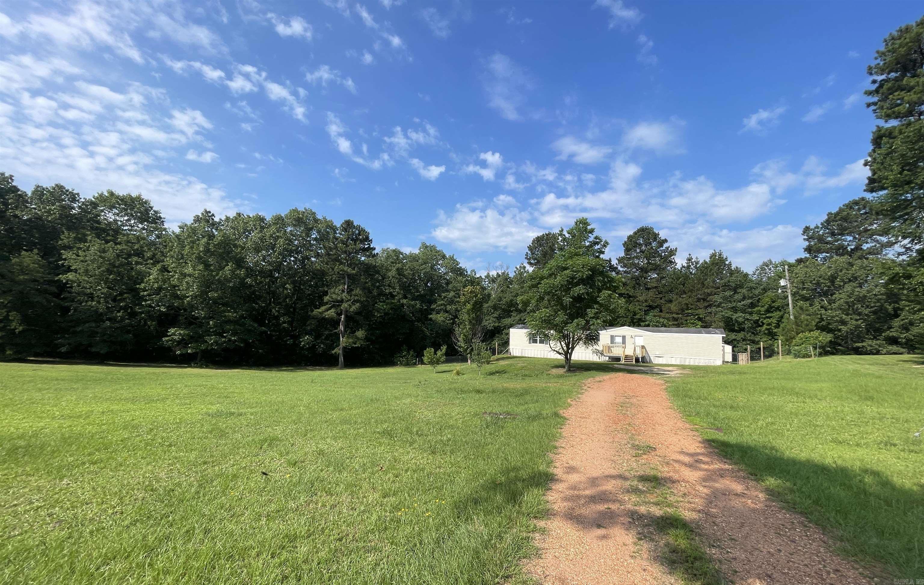 Quiet, peaceful living. Quiet retreat just outside the city. 1.3 acres. Mostly clearned. Large metal building. 2005 single wide, Clayton. New HVAC, updated bathrooms. Hablamos Espanol! $3,000 towards closing costs or upgrades!