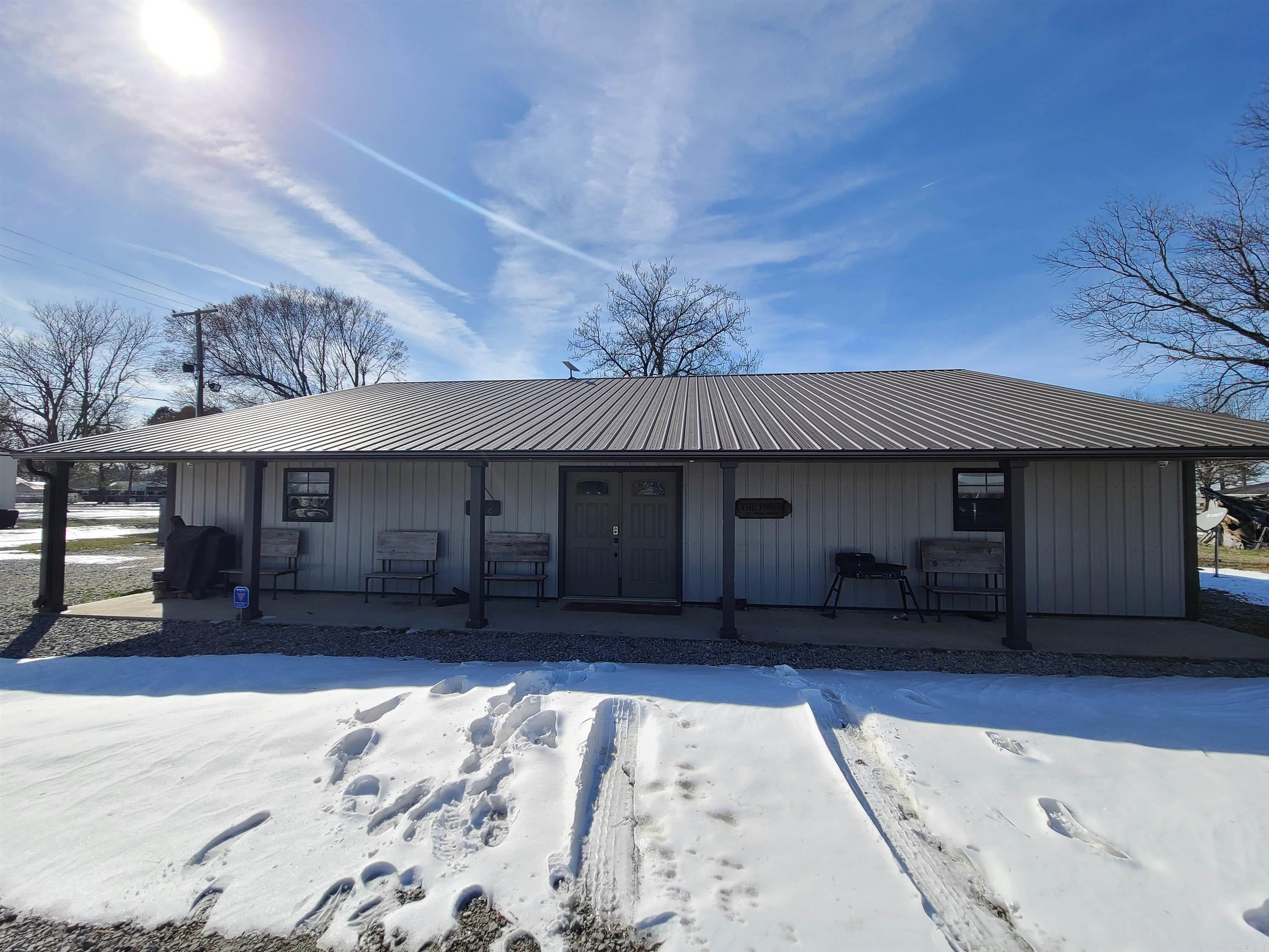 Calling all duck hunters, fishermen, and potential homeowners! If you're searching for a hassle-free place to call your base camp, the Welch Lodge is an ideal choice. Located in the peaceful town of Grubbs, Arkansas, just one mile west of the world-renowned Cache River, this lodge was built in 2019 with durability in mind. Enjoy a comfortable stay without the worries and high heating costs often associated with older farmhouses. Historically, the lodge has served as a short-term rental and provided overflow accommodations for hunters from the nearby main hunting lodge. Key features include sleeping arrangements for up to 17 guests, a commercial-style kitchen, a spacious living area, three bedrooms, one and a half baths, a full-length front porch, a 12x24 storage building, and a fenced backyard perfect for your hunting dogs. Pack your bags and head on over to your new fully furnished lodge!