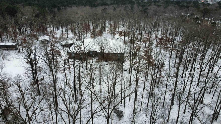 AMAZING RARE FIND! LIKE HAVING YOUR OWN PRIVATE PARK! Almost 12 ACRES w custom built one level 5 bed 3 bath home. Watch deer, fox, owls, hawks, etc from the hot tub next to a fireplace on the giant screened in porch. You will not find anything like this. Huge 4 car garage with oversized doors for all your toys, plus extra carports outside. Beautiful hardwoods and extra landscaping. Seclusion and luxury mere minutes from anything you want. Chef's kitchen with gas cooktop and double ovens, 2 fridges convey. 2 laundry rooms. Primary en suite is like a spa! Tornado safe room off of MIL quarters. Ventless gas log fp in main room. 3 HVAC zones with wifi thermostats. If you work from home, this is the place to do it! Once in a lifetime chance to own a private park-like estate in the city. Wonderful place to entertain. EV charger, tankless HWH, generator plug in ready for if power goes out. Diamond polished concrete floors throughout for easy living. Solid doors. See agent remarks for extra info.