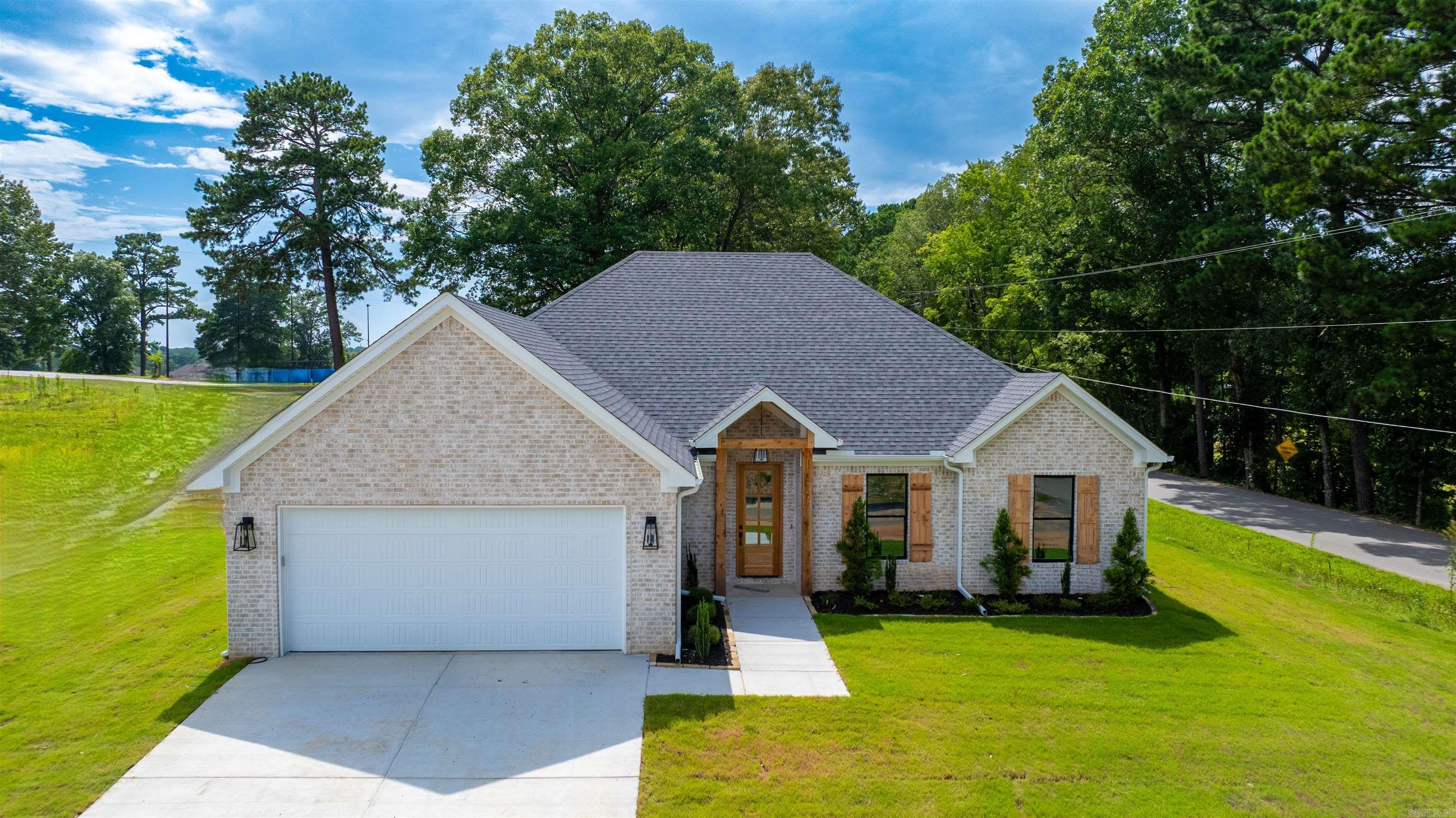 Home is on corner lot!! has LVP flooring, custom cabinets, large pantry, kitchen over looks great room with custom fireplace. Laundry room has sink with lots of cabinets. Primary has tile shower with free standing tub.
