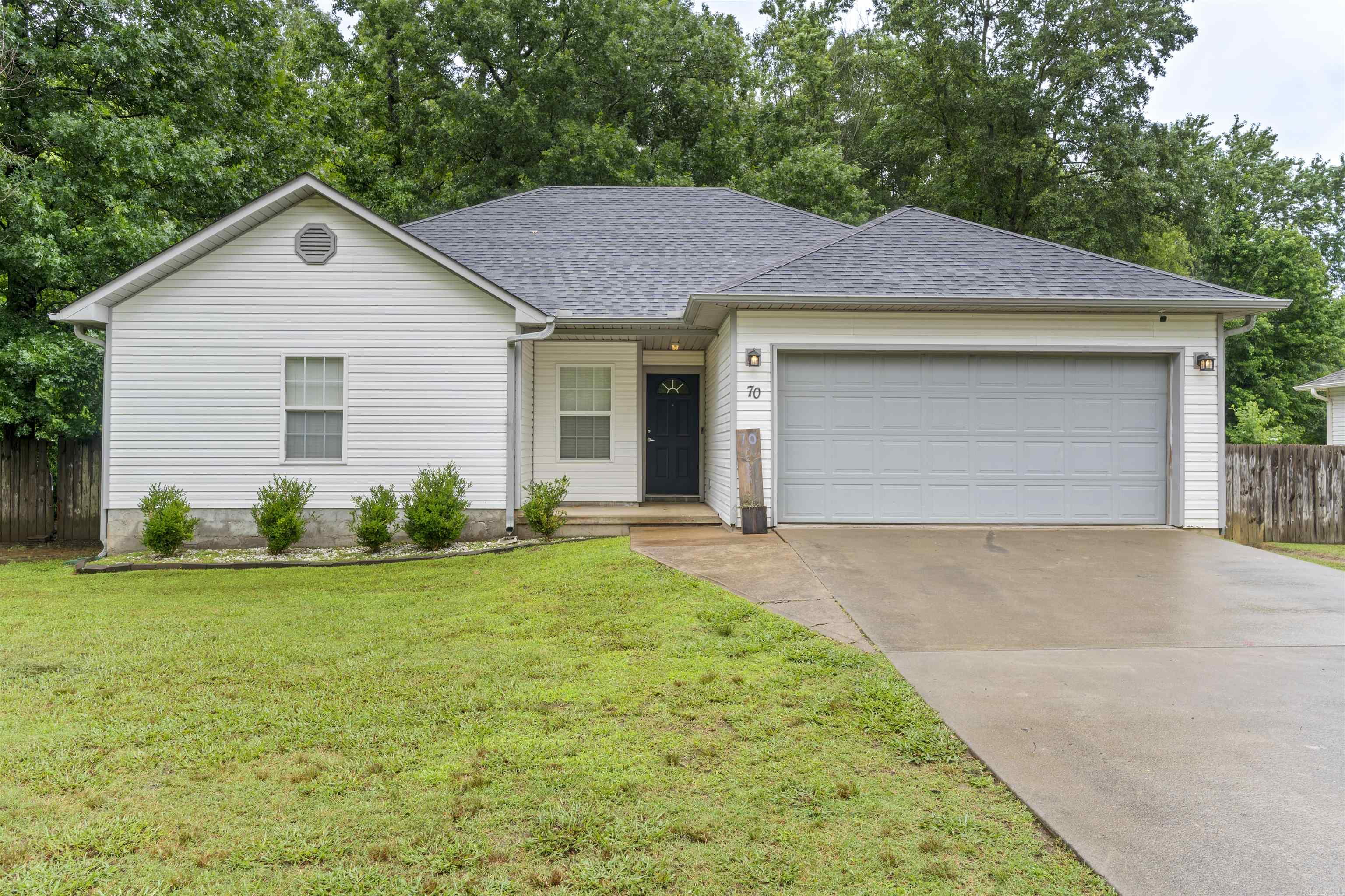 Updated starter home on quiet street in Austin. This 3 bed 2 bath includes 4.26 acres of mostly wooded land with many updates inside. Inside you'll find and open concept living/dinging/kitchen area with the living room having a large vaulted ceiling. New flooring throughout, updated paint, new hot water heater, new primary shower/tub combo, and updated back door. Outside you'll find an extra storage room, new deck overlooking a private backyard with a small creek. New roof 2022. A great home that also includes an alarm system, all electric, and split ac unit for the garage. Sq ft Approx., measurement encouraged. Flood insurance required.