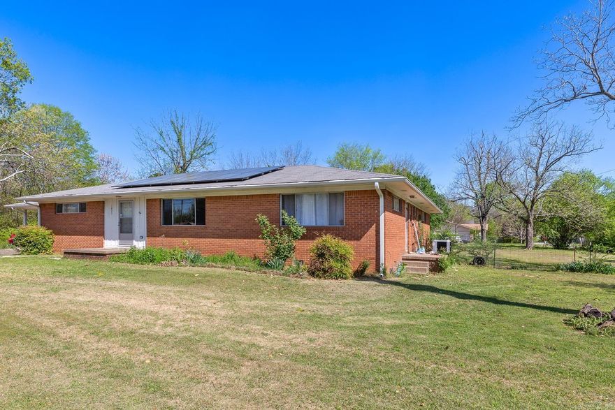 Mid-Century ranch style home on large corner lot. 4 bedroom 2 bath brick home with lots of room. Over 2000 sq. ft., central heat and air. Includes a shop/garage in back. Property does have solar panels.