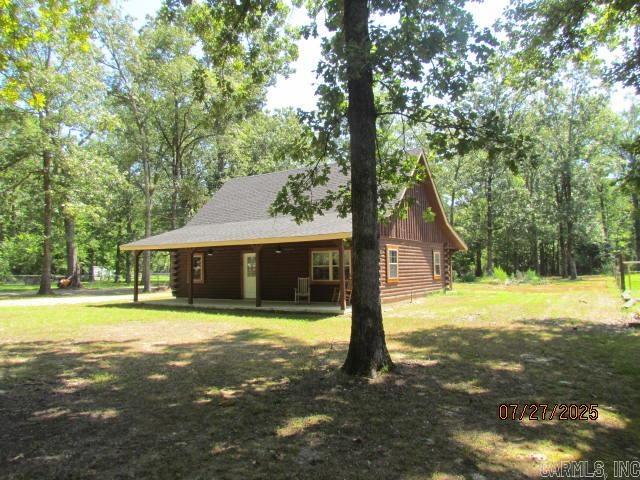 Welcome to this beautifully maintained log home offering rustic charm and modern comfort on a spacious 0.93-acre lot. With 1,512 sq ft of living space, this home is perfect for families or anyone seeking a peaceful retreat. ? Features You'll Love: New Roof & HVAC, Painted through out home, new light fixtures and fans. Large Lot .93 A Inviting front porch with new ceiling fans and new front door Spacious living room with vaulted ceilings, exposed log walls, and open staircase Open-concept kitchen with electric stove, refrigerator, and dishwasher-ready space Cozy back porch—also with new ceiling fans—ideal for relaxing or entertaining Two downstairs bedrooms with a mix of natural log and white accent walls Luxury vinyl flooring throughout the main level Full bath with walk-in shower and laundry closet with washer/dryer hookups Upstairs features a large master suite, private bath, and bonus room with closet $3,500 carpet allowance offered at closing for upstairs customization to replace flooring. This home blends warmth, space, and functionality—ready for you to move in and make it your own.