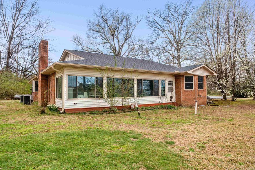 Welcome to this beautiful 3 bedroom, 2 bath home situated on 2 peaceful acres in the highly sought-after Lakeside School District.  Thoughtfully updated, this home features new flooring throughout, offering both style and durability.  The inviting living area is anchored by a wood burning fireplace, perfect for cozy evenings while the bright sunroom provides a relaxing space to enjoy views of the surrounding property year round.  The spacious layout offers comfortable living with plenty of natural light and room to spread out both indoors and out. This property offers the perfect blend of privacy, comfort, and convenience just miniatures from town while still enjoying a county feel.  New roof 2025! A rare find with acreage in Lakeside-don't miss this opportunity.