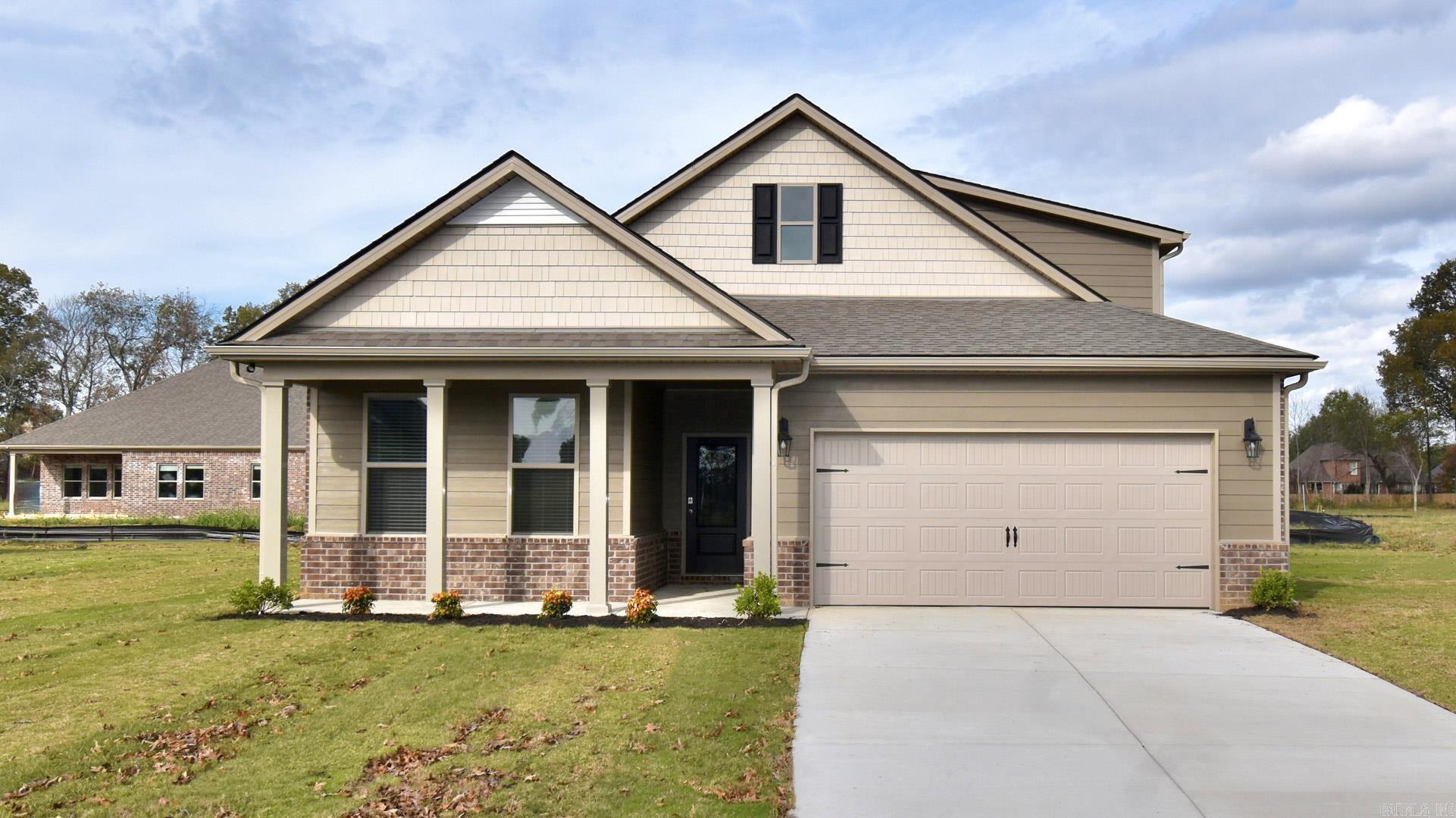 Under construction. The appealing one-story home includes many contemporary features. An open-concept design including 9' ceilings enhance the wonderful feel of this home. The kitchen includes a large counter perfect for bar-style eating or entertaining, a spacious pantry and plenty of cabinets and counter space. The large living room overlooks the patio, which is a great area for relaxing and dining al fresco. Bedroom One, located at the back of the home for privacy, can comfortably fit a nice size bed, and includes an en suite bathroom with a vanity and big walk-in closet. Two other bedrooms share a second bathroom. The two-car garage connects to a small hallway where the laundry room is located. Pictures, photographs, colors, features, and sizes are for illustration purposes only and will vary from the homes as built. Additional Features include: granite countertops, kitchen appliances provided are refrigerator, stove, microwave, dishwasher, electric fireplace, brick, gutters, blinds, double sinks in master, walk in shower, 2 car garage, 10 year warranty.