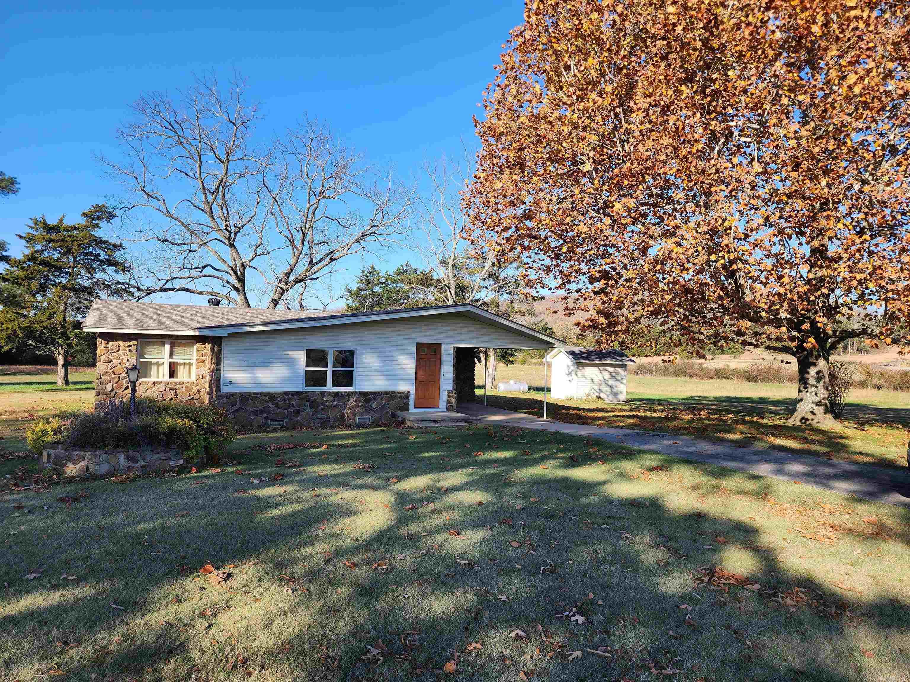 This charming 3-bedroom, 1-bath stone country home sits on 3 beautiful acres, surrounded by rolling farmland. The timeless stone exterior offers character and blends perfectly with the peaceful rural setting, creating a serene retreat. Inside, the home features a cozy layout, ideal for comfortable living. The living area is inviting and perfect for relaxing, while the kitchen and dining spaces are well-suited for daily meals and gatherings. The three bedrooms provide quiet retreats, and the single bathroom is designed for practicality and convenience. Outside, the property offers plenty of space for gardening, outdoor activities, or simply enjoying the countryside views. Completing this idyllic setting are a small barn and a storage building, adding versatility and practicality to the property. With its charming design, spacious lot, and picturesque setting, this home embodies the simplicity and beauty of country living.