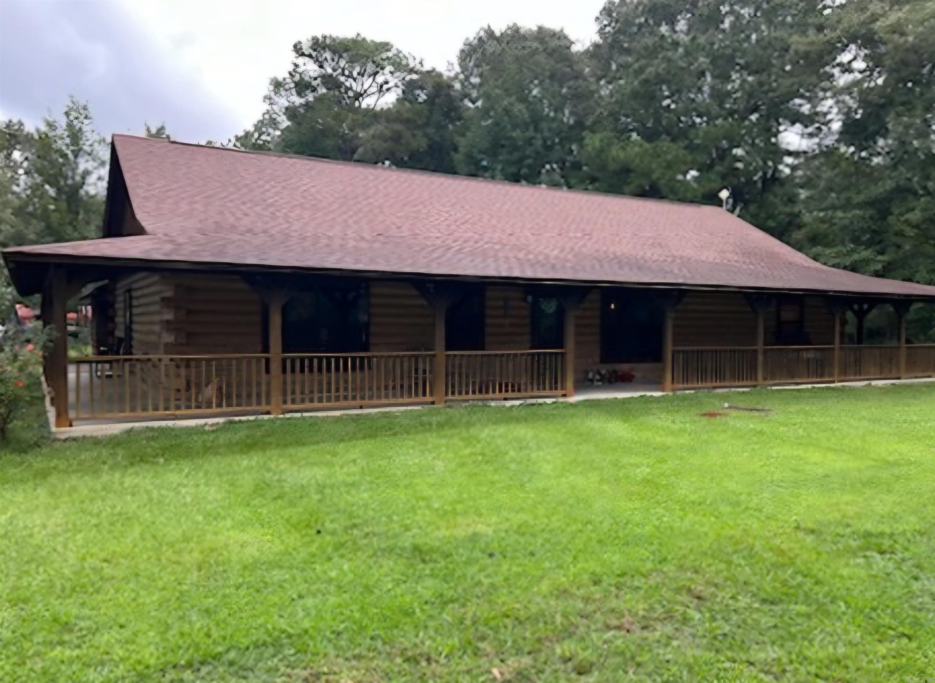 Nestled just outside the city limits of Monticello, Arkansas, this stunning custom-built log home offers the perfect blend of rustic charm and modern comfort. Situated on 9.14 acres, the property provides ample space and privacy while remaining conveniently close to town. This 1,920 sqft home features 3 spacious bedrooms and 2 full bathrooms. The open concept kitchen and living area serve as the heart of the home, ideal for family meals, celebrations, and cozy nights in. The expansive wraparound porch offers scenic views, perfect for morning coffee or weekend gatherings with friends and family.A mancave is attached to the carport, providing the ideal space for relaxation or hobbies (or a "she-shed" for those looking for a retreat). The property is easily accessible from a paved county road, with a gravel drive leading to a large 24x30 red iron metal shop and a covered carport, making it perfect for storage or workshop needs.The land itself features about 2.5 acres of timber, offering the perfect balance of nature and functionality. Don't miss the opportunity to own this beautiful home and land in a prime location! Schedule a showing today!