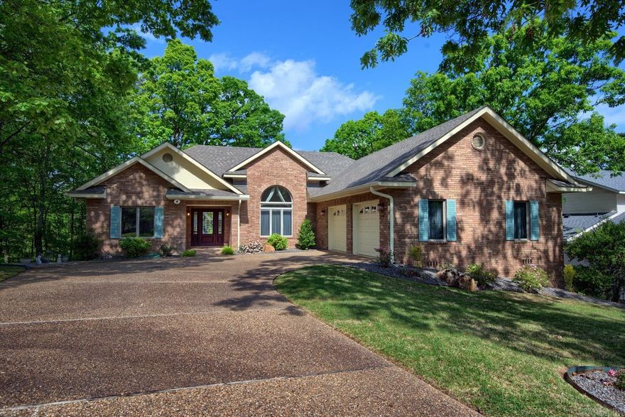 A SERENE RETREAT!  Meticulously landscaped, this tastefully designed custom-built one owner home welcomes you with ambiance and charm. Step inside and experience the bright, easy flowing floorplan with its vaulted ceilings, cozy gas fireplace, and walls of windows overlooking the expansive deck and wooded, peaceful backyard. The sparkling kitchen features a fresh, timeless aesthetic of custom cherry cabinetry, quartz countertops, and stainless steel appliances.  Just beyond the kitchen is the huge utility room including extra storage cabinets, sink, counter, and access to double side-entrance  oversized garage. The owner's suite boasts a lavish ensuite bath, walk-in closet AND a bright, tranquil sunroom with private access to the deck! On the opposite side of the residence is the guest wing featuring 2 bedrooms and a full bath or office/den and a guest room. On the patio level, guests or the homeowner can enjoy the heated and cooled bonus room with closet and full bathroom.  Make this serene retreat yours today and enjoy sharing it with family and friends or just relaxing in your private paradise! *New roof 2022 *New heat pump 2020