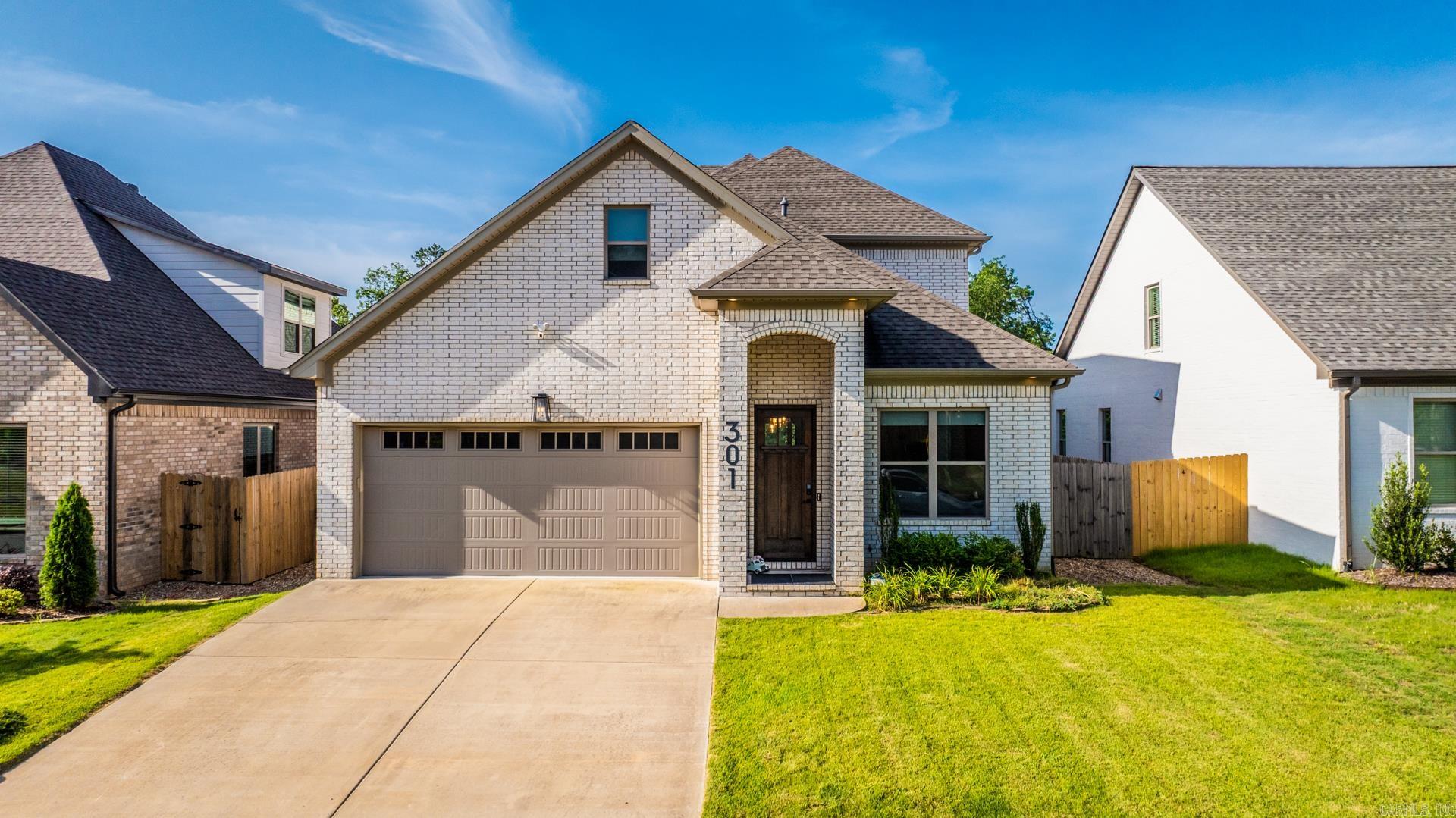 This is a Dillon Homes trophy Custom with 4 Beds & 3 Baths in the super convenient & well kept Kanis Ridge of WLR. Enter to find your 12’ ceilings, luxury vinyl floors, and fresh paint throughout. At the entry is a nice dining / entry living area and sliding door to your office with the open shelf built-ins. The open living is wrapped with windows, giving great natural light to illuminate your hearth room with the gas log fire with the floor to ceiling stone tile and seated storage built-ins, plus access through the sliding glass door to your flat and fully fenced irrigated zoysia yard backing to private greenery. The gas grill at your covered back patio can stay. The chef’s kitchen gifts a gorgeous natural quartzite breakfast island, a built-in gas stove, smart convection oven, champagne hardware on the custom cabinetry, a quartzite blessed walk-in pantry, and immaculate breakfast/dining area. Take the stairs to find your additional 3 Beds & 2 Baths, including your spacious primary suite with great views over the greenery, and impressive bath with the walk-in seated rain shower. The laundry is conveniently placed between the primary & guest suites.