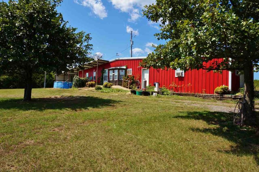 Nice piece of property in the country.  Great for horses!  Property features a 1300 sqft metal building home with one bedroom, a large living area, and 1.5 bathrooms.  Home also has bonus 720 sqft shop area attached, as well as a carport.  Property is fully fenced and has a barn with loft.  Come make this place your home, or live in home while you build your own! Mineral rights do not convey to Buyer.