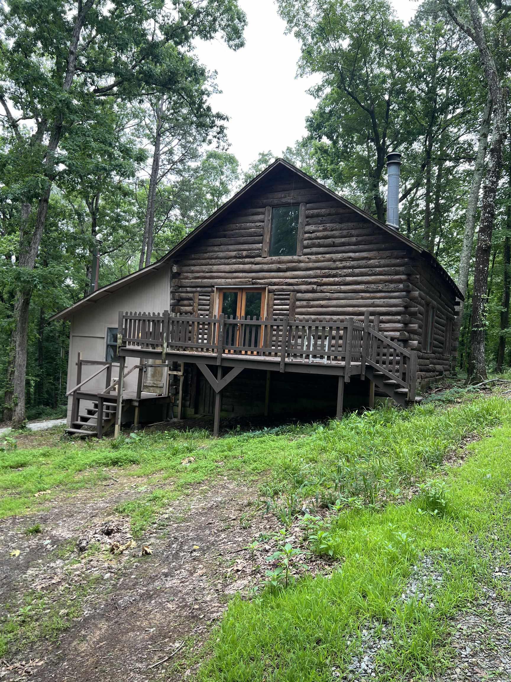 Turnkey log cabin on prime West Little Rock lot. This home with mother in law quarters is a one bedroom, one bath studio on the South side and two bedroom two bath on the North side. Secluded and quiet location continently located close to West Little Rock shopping & dining. Two bedroom side has quaint fireplace and loft bedroom. Both sides have washer and dryer hookups and full kitchens. Home to be sold as-is, agents, see remarks.
