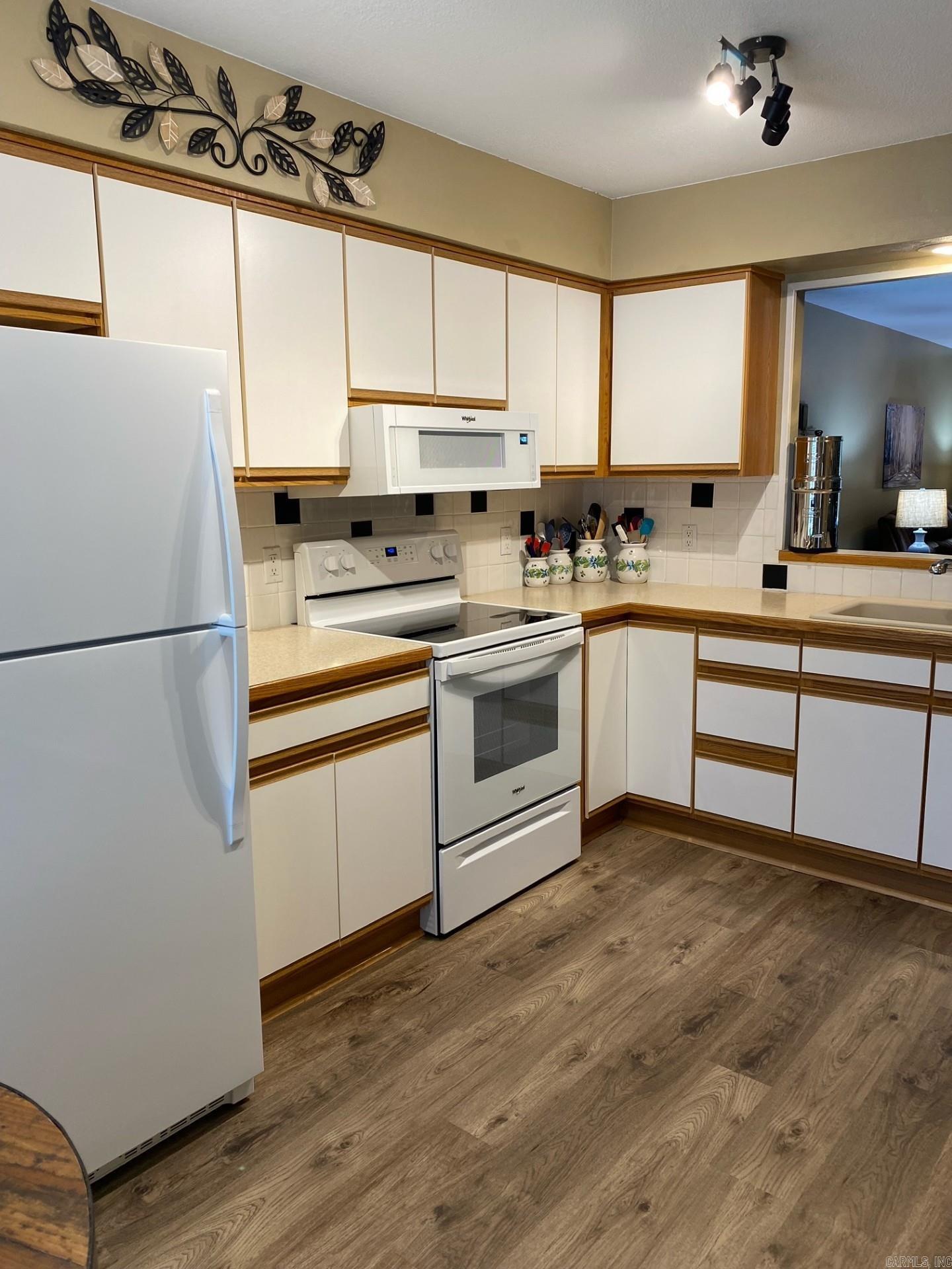 MOVE IN READY!!! This beautifully updated townhome in desirable Majorca Court blends style, comfort, and low-maintenance living. Enjoy neutral LVP flooring and paint throughout, plus an updated kitchen with 2 roll-out shelves and track lighting for a well-lit cooking space. The spacious owner's suite includes a walk-in closet, ample vanity storage, a walk-in shower, and access to an adjoining half-bath. Truly move-in ready! A larger covered front porch (the only one in this court!) welcomes you in, and the heated/cooled sunroom adds year-round living space. Step onto the extended deck overlooking a peaceful wooded area. Major upgrades include a 2023 HVAC system and 2021 water heater. The exterior was freshly painted this month. This rare opportunity sits near scenic Lake Pineda and is close to the Coronado Center, library, Fitness and Tennis Centers, Lake Coronado, and several golf courses. Friendly, walkable neighborhood. Schedule your showing today!