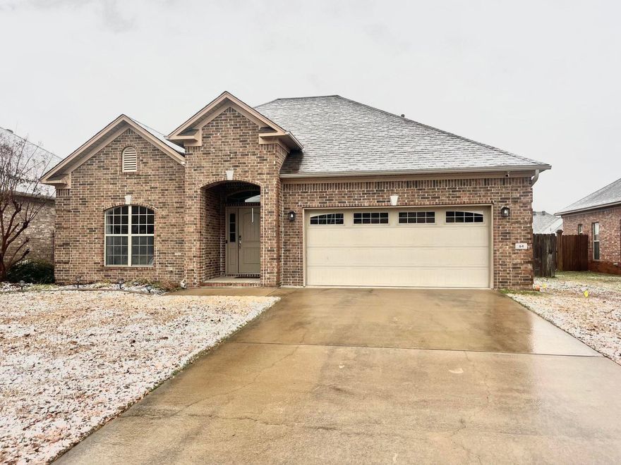 This pretty as a picture 3 bedroom, 2 bathroom brick home in a charming community. As you enter, you will be greeted with sleek wood flooring, stretching into the comfortable living area. This immaculate home has updates throughout, crown molding and a beautiful gas fireplace. A new roof was installed in 2022, and the water heater was replaced in 2021. Each bedroom features a sizable closet and a neutral color palette to match any style. Venture through the back door to find a covered patio and a spacious fenced backyard... the perfect place to build a snowman soon or watch the dogs and kids play! This home is ideally located minutes from shopping, dining, and major roadways for easy commuting.