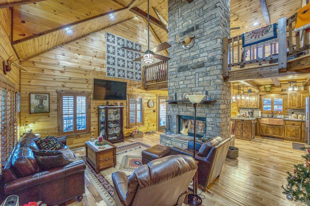 What an unbelievably rare and special tract overlooking the famous Bear Creek Valley. This stunning farm is loaded with features you just canāt duplicate and has something to offer any buyer. Tucked in the majestic valleys of this stretch of the Ozark Mountains is a wonderful farm with established pasture and excellent hunting potential. Conveniently located on Hwy 27 South, the access is very easy and just a few miles from the community of Marshall, AR. The newly constructed masterpiece true log cabin is tucked on the hillside amongst the towering pines. This marvel is full of custom features like granite countertops, vaulted ceilings, custom alder doors, a towering freestanding dual-sided rock fireplace, an oversized covered wrap-around deck, custom hickory hardwood flooring, real wood blinds, and much more. Entering the home, you walk through a spacious laundry/mudroom area with expansive cabinetry and ample storage. A massive master suite offers large closets, custom wood accents, and a separate exit to a beautiful sunroom that not only offers a cozy coffee nook but is also heated and cooled and would be ideal for a dog space. This also leads to the remarkable covered deck.
