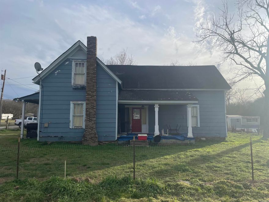 Investment Opportunity in the Heart of Quitman!  Located on a large corner lot just a short walk to the town square, 710 Locust St is a two-story Craftsman-style home (1955) offering 2,184± SF and being sold As-Is / Where-Is. The layout allows for a main-level primary suite with a bath and three additional bedrooms and bathroom upstairs, featuring tall ceilings and spacious rooms throughout. What sets this property apart is its income-producing potential. The offering includes 714 Locust St, an older single-wide mobile home with addition, covered patio, and existing power, water, and septic—ideal for renovation, replacement, or a tiny home setup. In addition, a separate lot with Elm St access provides its own power, water, and septic, allowing for another mobile or tiny home. An additional water meter and electric service are also in place, suitable for an RV or extra tiny home. With strong local schools and small-town charm driving consistent rental demand, this is a rare multi-unit investment opportunity in downtown Quitman.