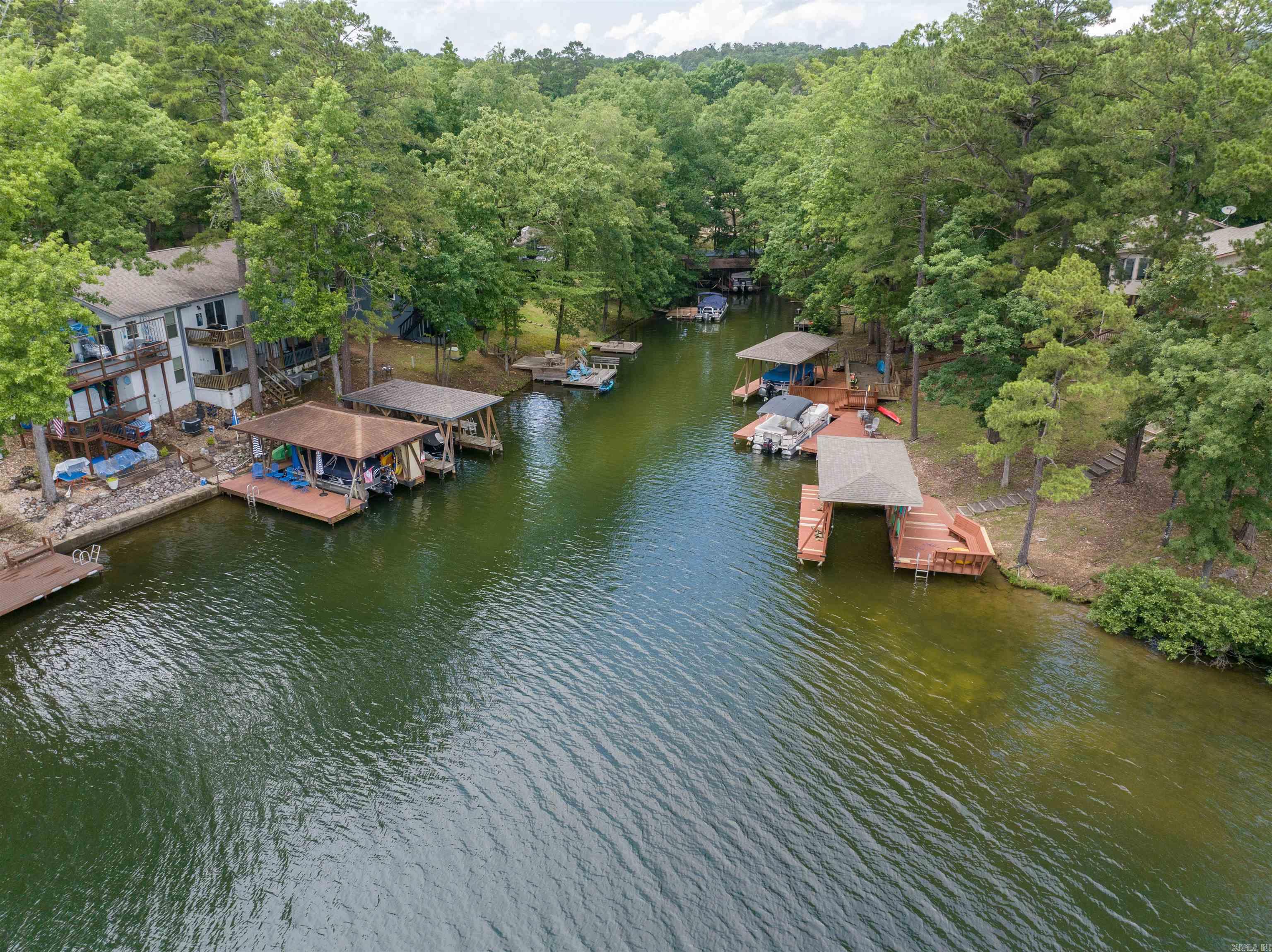 3 Bedroom WATERFRONT townhome on Lake DeSoto! Enjoy Sunsets from your Back Deck or the Lower Patio! BRAND NEW ROOF going on soon! These units make great Nightly Rentals! There is an oversized Laundry/Storage/Owner's Room (in addition to the 3 Bedrooms). Lake DeSoto is one of 4 Full Recreational Lakes in Hot Springs Village (water ski lake)! This 200 acre lake offers a Beach, the Waypoint Marina, Boat Launch and Walking Trails! Hot Springs Village boasts 11 Lakes & 9 Golf Courses, Tennis, Pickleball, Mini Golf, Bocce Ball, Lawn Bowling, Dog Park, Fitness Center, Indoor & Outdoor Pools, Performing Arts Center, Archery Range, 20+ Miles of Walking Trails, and much more!