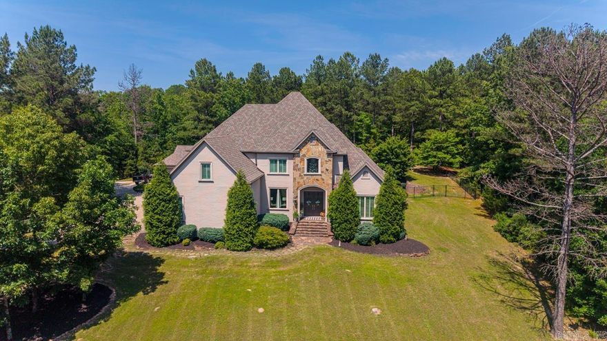 This beautifully designed custom home is tucked away on a private 2.67 acre lot (2 lots)and offers 4 bedrooms, 4 full baths, 3 half baths, large primary suite on main level with safe room in closet,  bonus room, office, flex space, large family, room and separate den, chefs kitchen, with large pantry and butlers pantry, 2 fireplaces, sprinkler system, tankless water heater, tall ceilings, hardwood floors throughout (tile in wet areas) stunning salt water pool with fountain with pool house with half bath  seller has extended drive to full circle drive, 5 car garage, added all new pool lights, installed sonic ice ice maker, and had new a/c installed