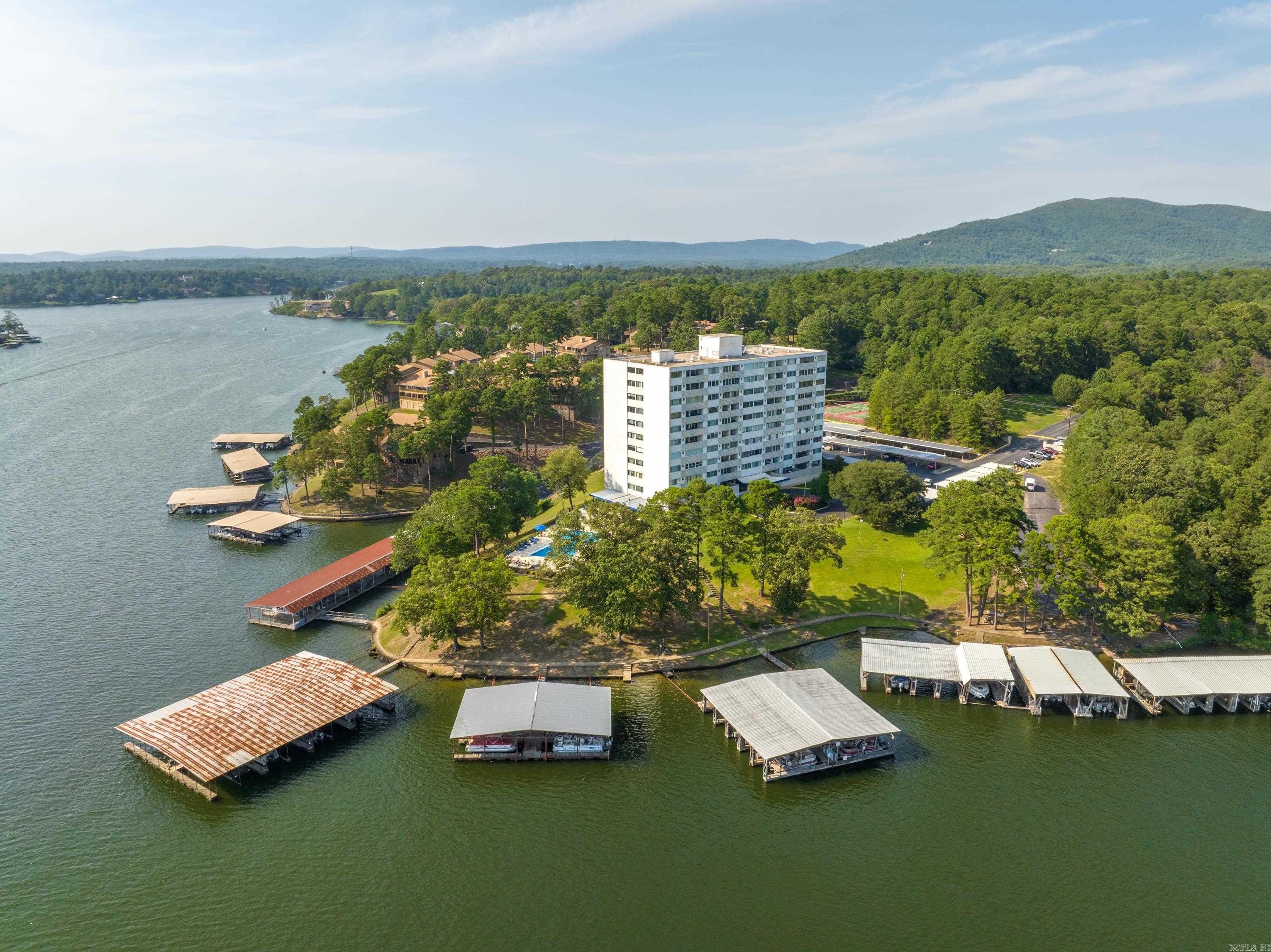 INVESTORS TAKE NOTICE - Beautifully updated, FULLY FURNISHED, move in ready Lake Hamilton 2 bedroom 2 bath condo perfect for short-term vacation rentals or weekend retreat on first floor convenient to pool and all amenities. BOAT SLIP INCLUDED. Relax on the private patio in this 1,060 sq ft condo including refrigerator, washer and dryer and all furnishings making this property turn-key. Convenient Airport Road location close to everything. Complex features gated entrance, swimming pool, tennis courts, covered patio area, exercise/fitness room, pool table, tennis court, outdoor grills, manager's office, family room & so much more. Includes 1 covered parking space.