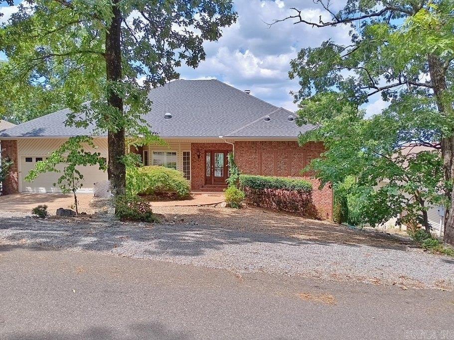 Priced to Sell! Stunning home with panoramic views of mountains and lakes. This custom-built beauty welcomes you with an elegant entry into a bright living room featuring tall ceilings, hickory hardwood floors, recessed lighting, and a cozy gas-log fireplaceāall framed by refreshing views through new Anderson picture windows. The gourmet dine-in kitchen boasts New Appliances, granite counters, breakfast bar, built-in desk, and sundeck access. Formal dining area easily converts to a media room or main-level guest suite. The spacious primary suite includes a private office/sitting room perfect for quiet retreats. The luxurious bath offers dual vanities and closets, a dedicated makeup area, relaxing soaking tub, and a fully tiled shower with dual wall sprayers. Enjoy the Refinished Partial Covered Sundeckāperfect for outdoor living with a natural setting. The lower level includes two guest bedrooms, sitting areas, a full bath, and walk-out access to a covered patio, providing privacy for visitors. Additional updates include efficient solar piping, two A/C units for zoned comfort, new carpet in guest room, updated water heater, new exterior hardware, and more