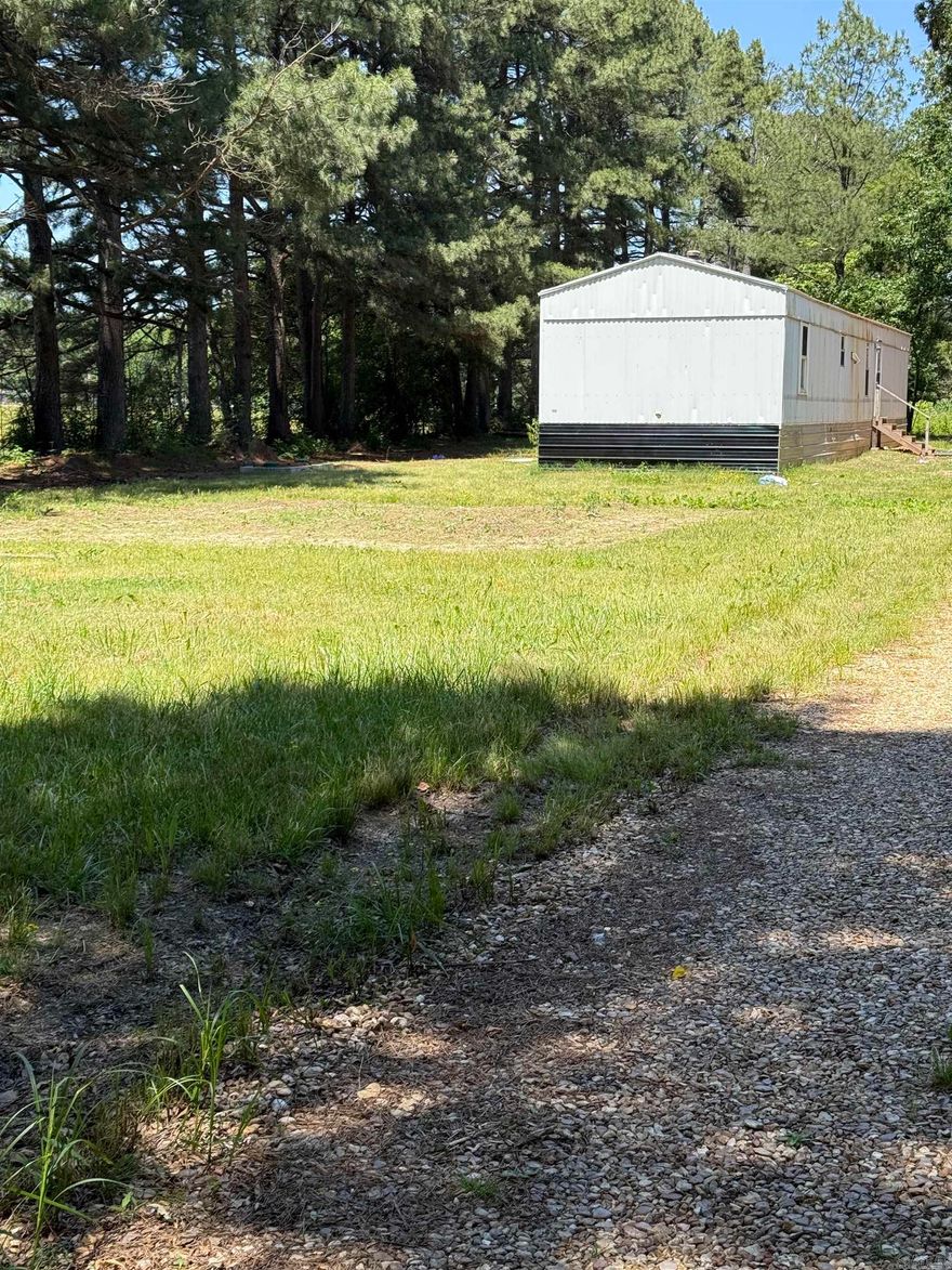 3 Bedroom 2 bath mobile home Sitting on 1.50 acre lot. North side of Paragould on paved road. There is a well and a newer septic. Not in flood zone. Good rental property. "SOLD AS IS"