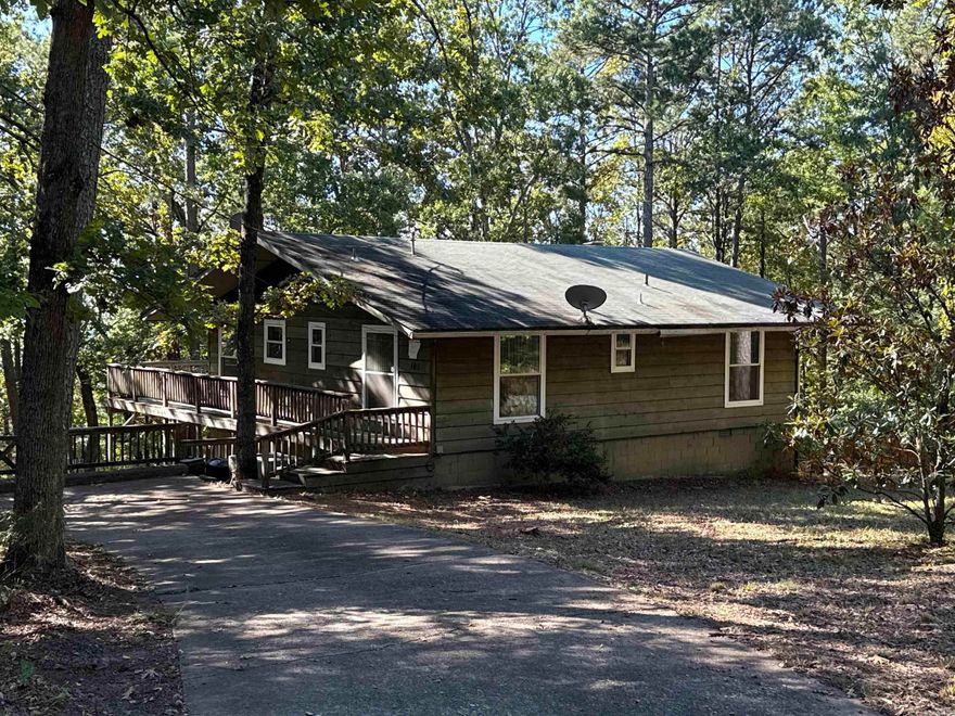 Quaint cottage near Greers Ferry Lake and all Fairfield Bay Amenities!  The main level has great room with wood-burning fireplace, 2 BR, 1Ba, kitchen, and laundry room.  A large deck in the back overlooks a natural wonderland, and slight  view seasonally.  HVAC replaced in 2024!!  A h/c lower level has a large 3rd bedroom for a game room/bunk room.(Outside access only). Heated & cooled.   Plus a shop or storage room.  (No inside access)  House is well-maintained.  Great for a fishing getaway, or just to enjoy your out-of-town retreat.  It’s partially furnished!  Can't beat this price!  You will have member access to the Fairfield Bay Resort amenities, including private golf course, 3 pools, parks, minigolf, bowling, restaurants, tennis and pickleball, and marina!!  Ask about the HOA dues and service fees.  AR