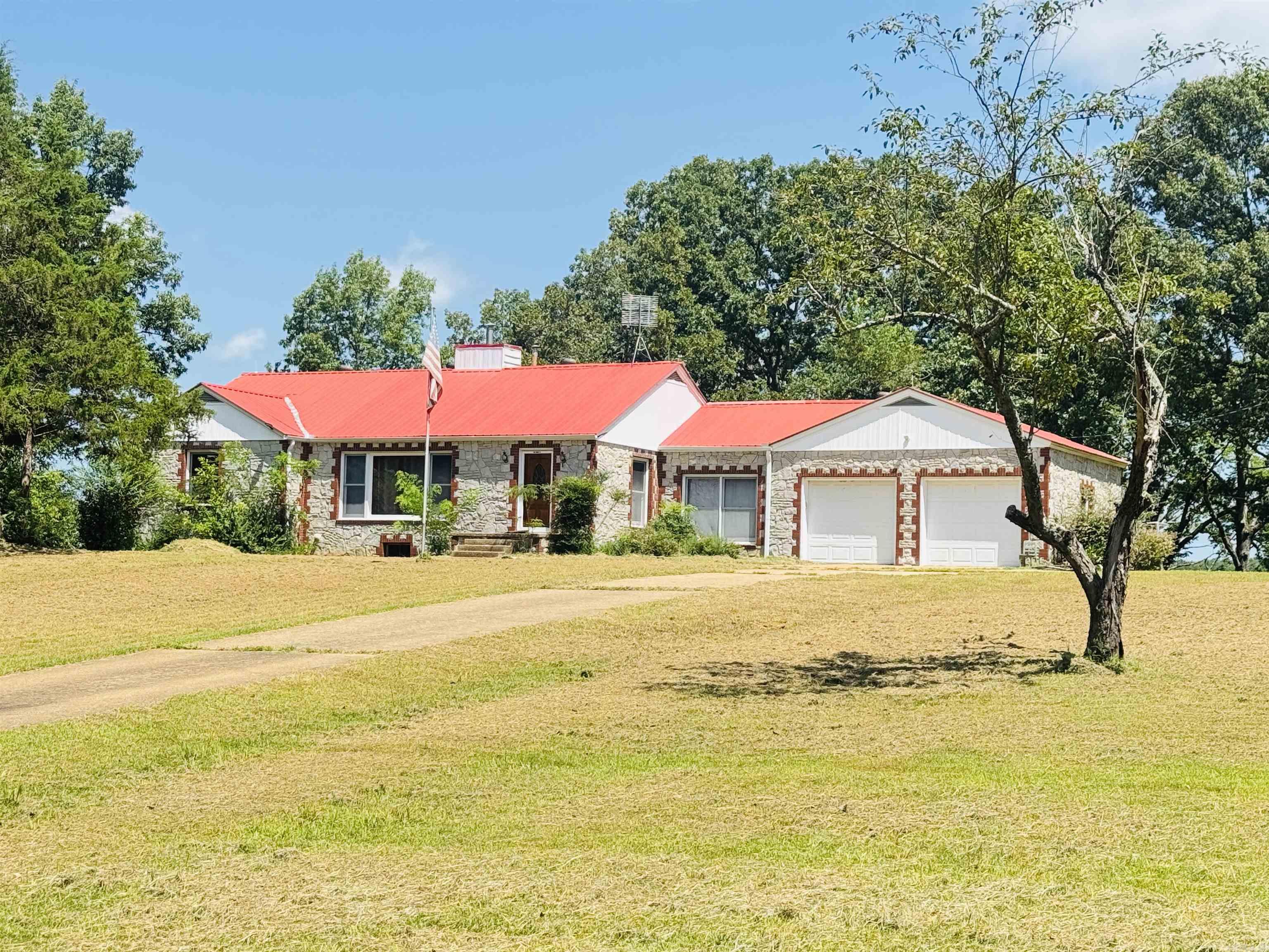 Located in the desirable Melbourne School District, this well-maintained home at 144 Larkin Road, Melbourne, Arkansas offers 1,560 sq ft of inviting living space with 3 spacious bedrooms, 1 full bathroom, a large living room with a wood-burning fireplace, formal dining room, oversized laundry room, and a kitchen featuring bright white cabinetry. The homeās unique stone exterior with red brick accents and a matching red metal roof adds great curb appeal. You'll also find cedar-lined closets and a 1,380 sq ft walk-out basement with sump pumpāperfect for storage or future finishing. Sitting on 3.45+/- acres, the property is dotted with mature shade and fruit trees, a favorite climbing tree, a chicken coop, and a two-car garage with an additional outbuilding featuring a floored interior and an overhead door. A concrete driveway with extra parking pads provides space for an RV, boat, or ATVs. Whether you're looking for a full-time residence or an investment property, this one is a must-see for only $199,000. Call today to schedule your private showing!