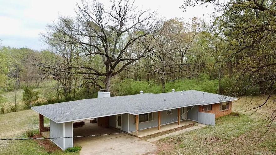 Mid-century charm meets modern elegance in this beautifully remodeled home on 1.3+ acres, surrounded by mature oaks for privacy while staying close to town. The custom kitchen features sleek cabinetry, Samsung stainless appliances, and a breakfast bar. Spacious formal living and den showcase picture windows framing the park-like landscape, while a huge sun patio (over 600 sq.ft of outdoor living space) offers the perfect outdoor retreat. Recent upgrades include a new architectural roof, luxury vinyl flooring, modern lighting, updated baths, and a new water heater. The primary suite boasts double closets and an en-suite bath, while charming built-ins and a cozy fireplace add warmth and character. A rare find blending timeless style with modern updates!