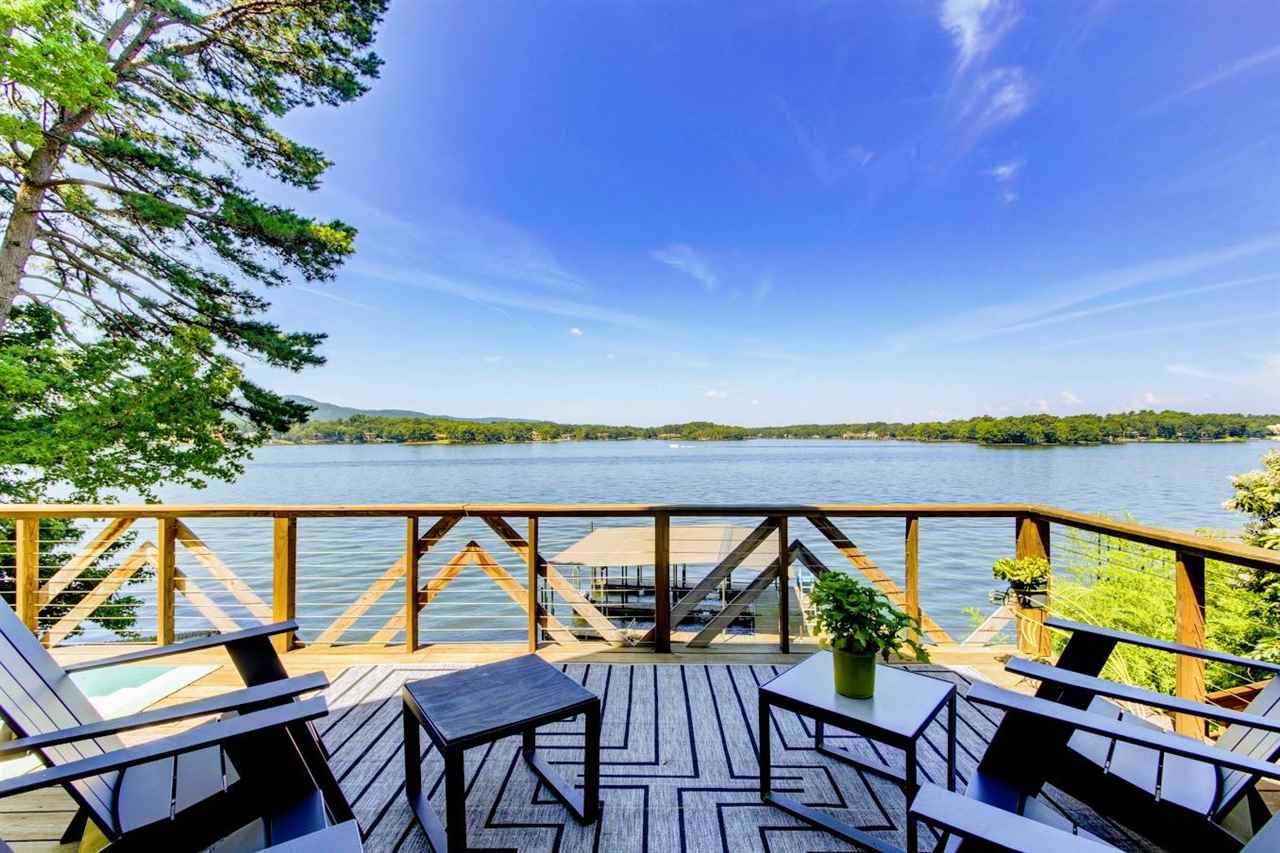 Prime Lake Hamilton vacation rental!! off Central Ave. with Epic Lake views from this one of a kind Mid-Century A-Frame on prime lakefront. The 3 level home consists of the 2 BR's, living space, 2.5 baths, deck and the Lower Studio, an efficiency w/ kitchenette, bathroom & patio.The private two-stall dock has lift & a water slide. This very popular unique vacation house currently used as two separate short term rentals. The numbers speak for itself. Don't miss this great opportunity.