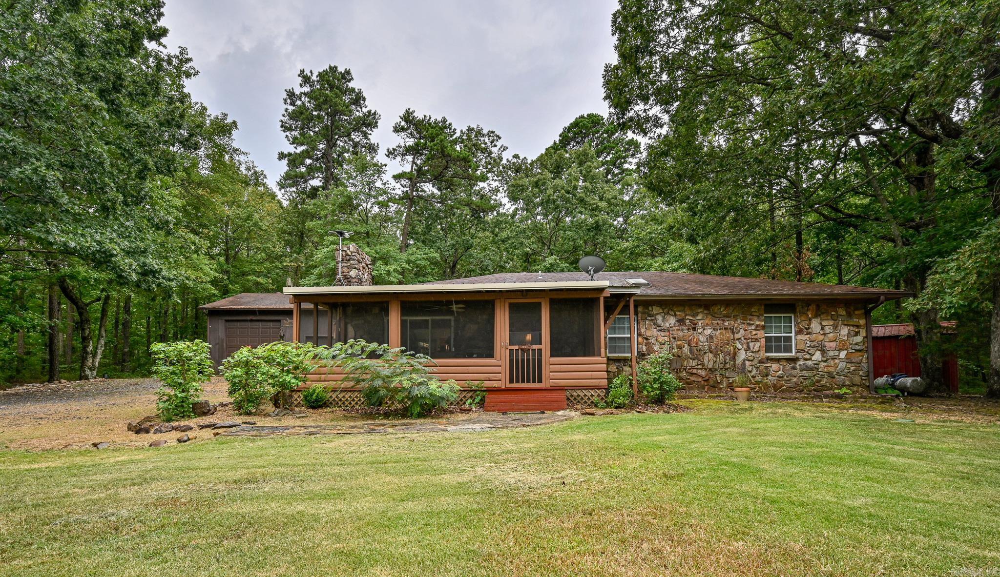 Mountain Living at its best! Two fully furnished homes, endless possibilities! Nestled in the breathtaking Ouachita National Forest, just 1.6 miles from Queen Wilhelmina Lodge & moments from the brand-new Ward Lake bike trails and under construction trails up to the top of Rich Mountain, this well-maintained property blends natural beauty with modern comfort. You’ll enjoy watching wildlife, breathing crisp mountain air, & having adventure right outside your door. Main home is native rock featuring a vaulted beam ceiling, fireplace with pellet insert, back fenced in patio & screened in front porch with mountain views! Second dwelling is a 1 bed/1 bath open floor plan log cabin with wheelchair ramp, 10' front porch & CH&A. Includes plenty of storage for toys and hobbies- 30x30 garage, 18'x28' cement block shop, pump house, 2 shooting ranges & 3 RV hookups. Please see documents for more details of what's included in this one of a kind property!