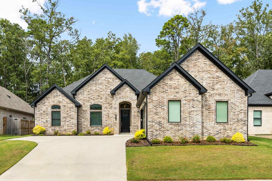 ONE LEVEL PATIO HOME IN GATED COMMUNITY!  This immaculate home features an open floor plan and is enhanced by a striking stone fireplace and 14 foot ceilings. The stylish kitchen features stainless steel appliances, quartz countertops, and a large pantry. The oversized primary suite offers a tray ceiling, a large walk-in closet, and a spa-like bathroom with a soaker tub and seamless glass walk-in shower. Additional bedrooms share a convenient Jack and Jill bathroom, and the fourth bedroom provides flexibility as a designated office or guest room with 14 foot ceilings. Enjoy seamless indoor-outdoor living with private backyard access and a view of woods…the patio includes a stunning vaulted ceiling, already equipped with utility hookups for your dream outdoor kitchen. A full sprinkler system on this pristine lawn ensures effortless maintenance. Bryant schools and close to Hwy 5!