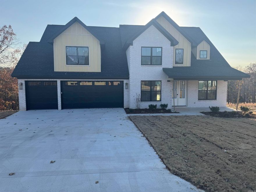 Prepare to be captivated by this stunning 4-bedroom, 3.5-bath home, defined by unmatched style and high-end details. Step inside to soaring vaulted and beamed ceilings over warm Warrington engineered wood floors flowing throughout the main level. Dramatic oversized windows captures views of the almost acre hilltop lot and floods the space with natural light. The chef's Kitchen is an entertainer's dream, complete with a walk-in pantry, dedicated coffee nook, and a stylish wet bar/prep area. The main-level Primary Suite is a true spa-like retreat, featuring a custom bath with a deep soaking tub, custom tiled shower with rain shower head, double vanity, separate makeup vanity, and a private covered porch. A dedicated Office and separate Dining Room, half bath, expansive laundry complete the main floor. Upstairs, you'll find three generous bedrooms (one with an ensuite), a split third bath, and a Bonus Room. With two covered back porches and a three-car garage, this home is truly exceptional. Square foot approximate please measure.  Updated progress! Almost Complete!  Professional photos coming soon.