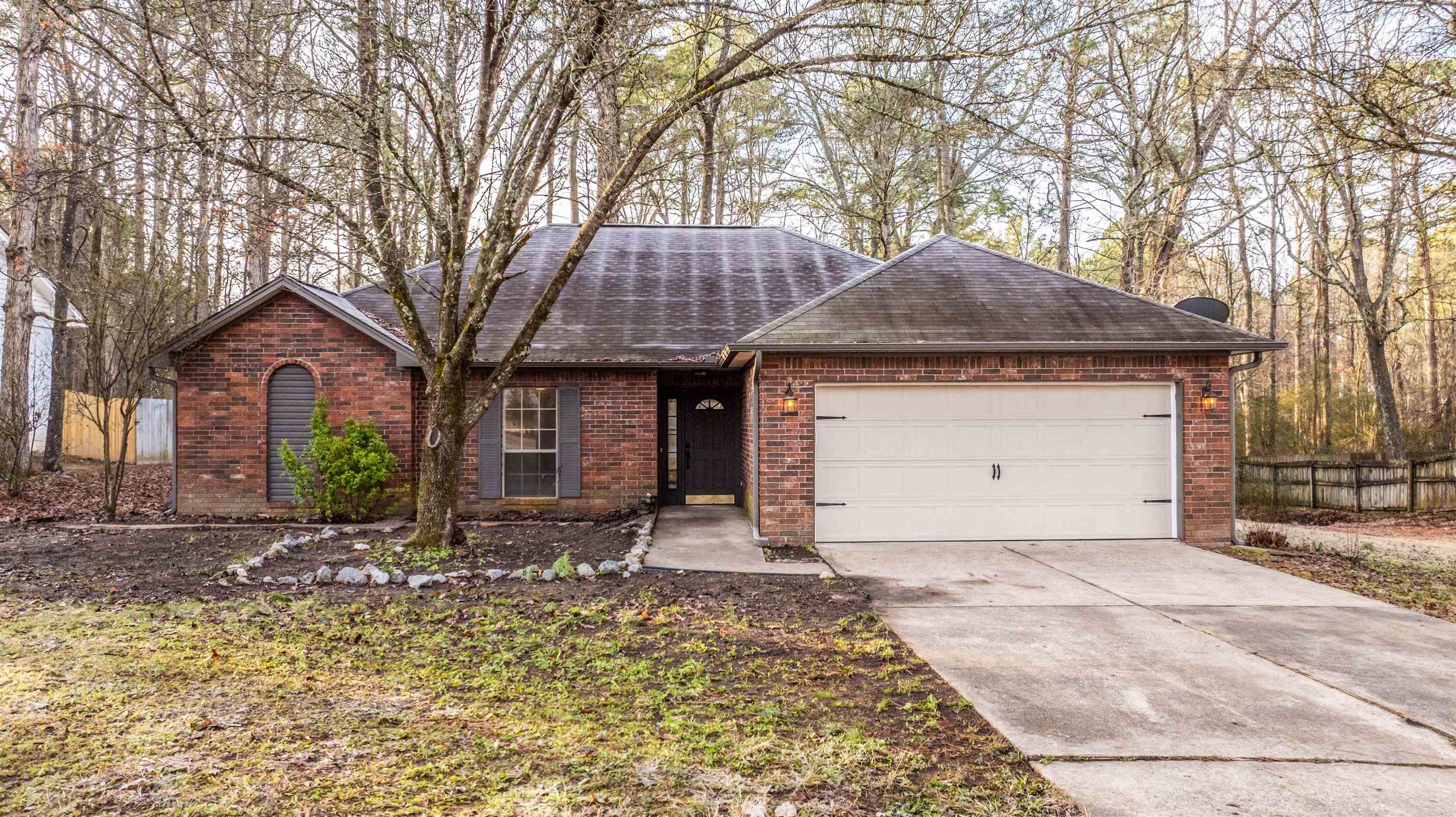 Charming and updated home less than a mile from Mills Park! This 3 bedroom, 2 bath home sits on a spacious lot and backs up to a creek giving you privacy and a peaceful outdoor setting. Inside, you'll find new flooring, updated fixtures, and modern hardware throughout. The spacious living area features a wood-burning fireplace and the kitchen has been updated with new appliances. All bedrooms offer extra large closets for added space. Located in the highly rated Bryant School District, this home has been professionally cleaned and is move-in ready! Schedule your showing today!