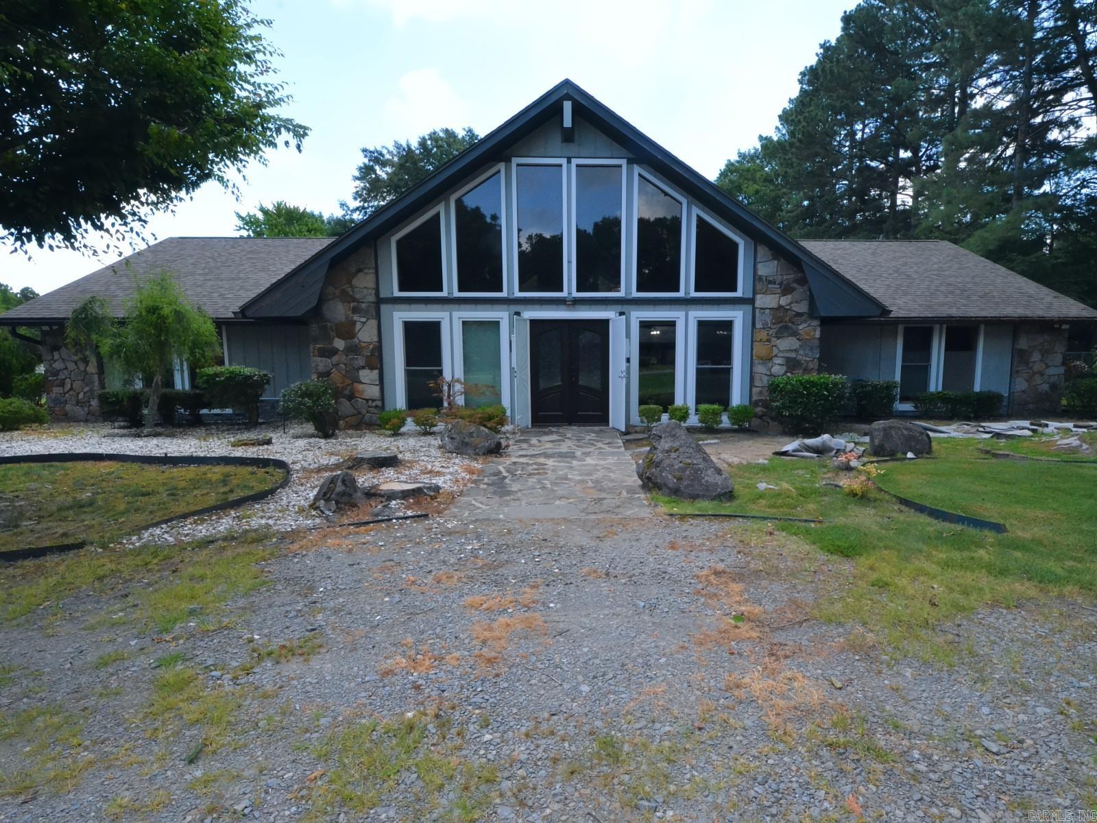 Welcome to your private retreat nestled on over one acre rural property! This beautifully updated home blends comfort and style with thoughtful touches throughout. The huge kitchen is a chefās dream featuring new stainless steel appliances, including a Viking 45" built-in cooktop, GE Profile microwave/oven combo, KitchenAid dishwasher, and under-counter beverage cooler. Large island with gorgeous granite countertops. The refinished cabinets include custom slide-outs, and organizers, there is a separate pantry, and a spacious laundry room. Each of the three main bedrooms boasts its own updated bathrooms and walk-in closets. The beautiful wood vaulted ceiling in the living room shows off the centerpiece, a massive rock fireplace, 60" ceiling fans, and new floor-to-ceiling windows. A versatile bonus bedroom/man cave offers a half bath and room to add a shower. Entertain year-round in the screened-in porch or enjoy quiet evenings on the concrete patio just outside one bedroom. This home has plenty of space for your family, is warm, inviting, and packed with many upgrades. Close to interstate 530, shopping, schools, and many modern conveniencesādonāt miss your chance to make it yours!