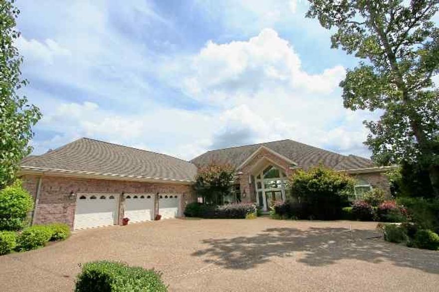 This 4-BR + study, 3-Bath treasure has custom cabinets throughout the house with Granite countertops in kitchen, Large custom designed brick see-through fireplace, lots of built-ins, panoramic view of lake and mountains. Complete with professional landscaping, a huge tiled patio, massive garage with lots of storage and work area, lighted seawall, sprinkler system and covered boat dock with entertainment area and much more. A MUST SEE!!