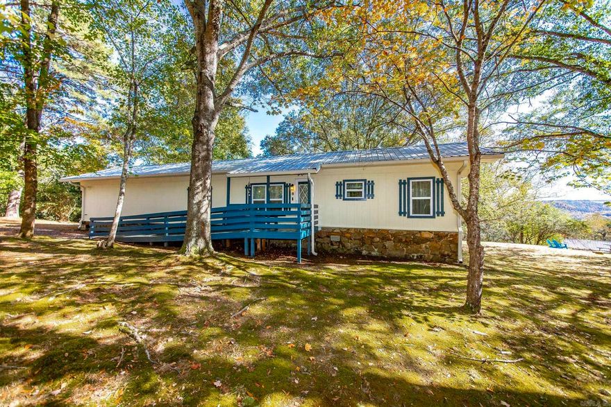 Adorable furnished getaway near the Middle Fork River of Greers Ferry Lake. Corner lot with 1.875 acres , fully furnished & setup as a successful short term rental over the last 6 years. All appliances are electric, home remodeled  & new metal roof installed in 2019.  See survey online under docs.  Only 1 minute (approx. .04 miles) to the river access by the Shirley Bridge, only 7 miles (approx. 12 minutes) to Fairfield Bay Marina, & only 6.1 miles (10 minutes) to Mountain Ranch Golf Course & Fairfield Bay SXS Trails, hiking trails, & bike trails.