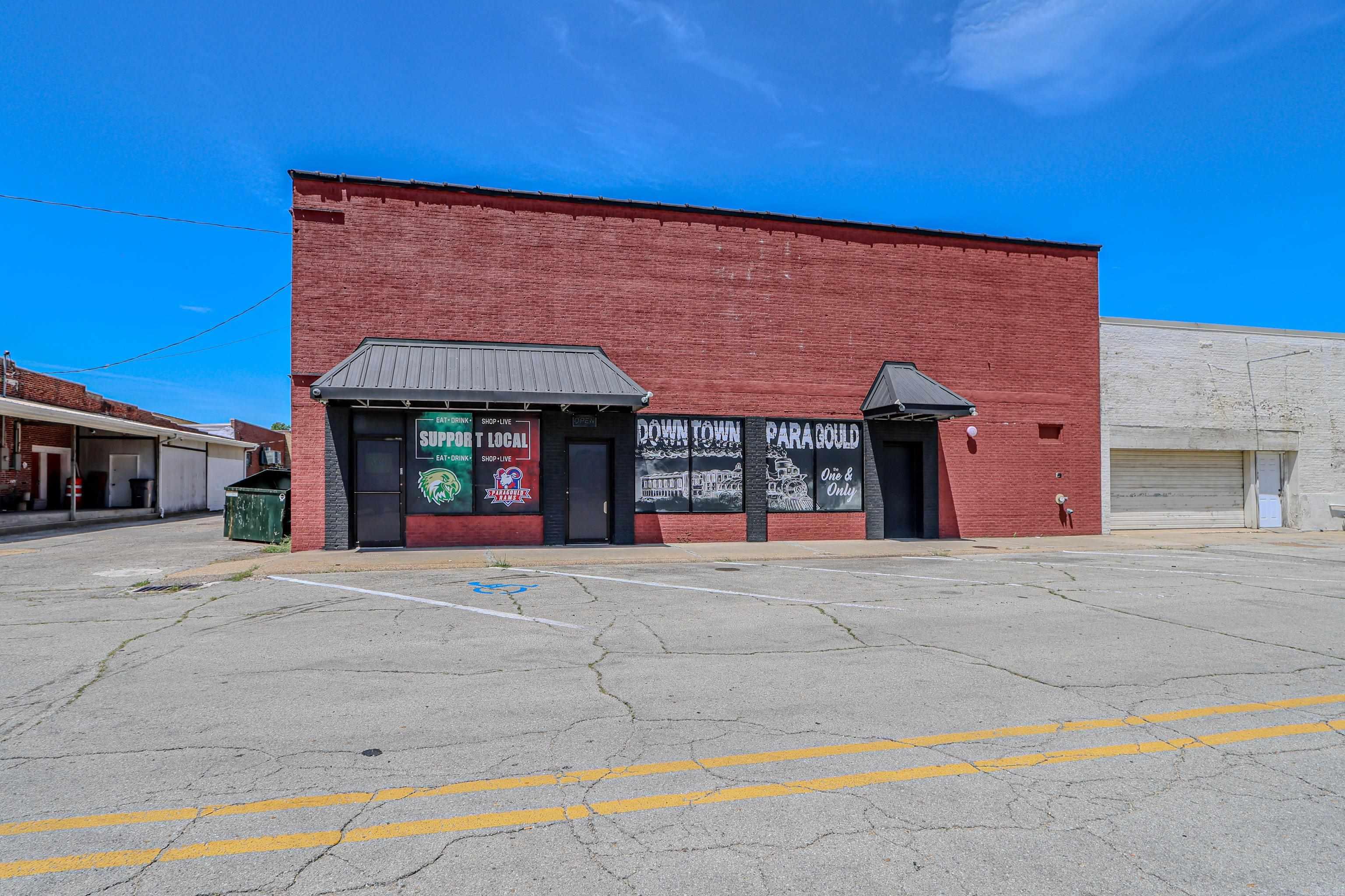 Exciting business opportunity for new owners in this currently leased space, this downtown building can later be split and used as retail, shopping, restaurants/bar, office spaces, there are two baths currently but could add more, if you are looking to own a unique building in downtown Paragould then look no more. 4200 sf. of space with Commercial Kitchen. Join the revitalization and growth in our downtown community Located near The Collins Theater, 1812 Pizza Company, Chow 118, Skinny J's, and several well established boutiques! Large open floor plan with bar seating, roll down interior doors if private space is needed, and 2 bathrooms. Zoned C1.