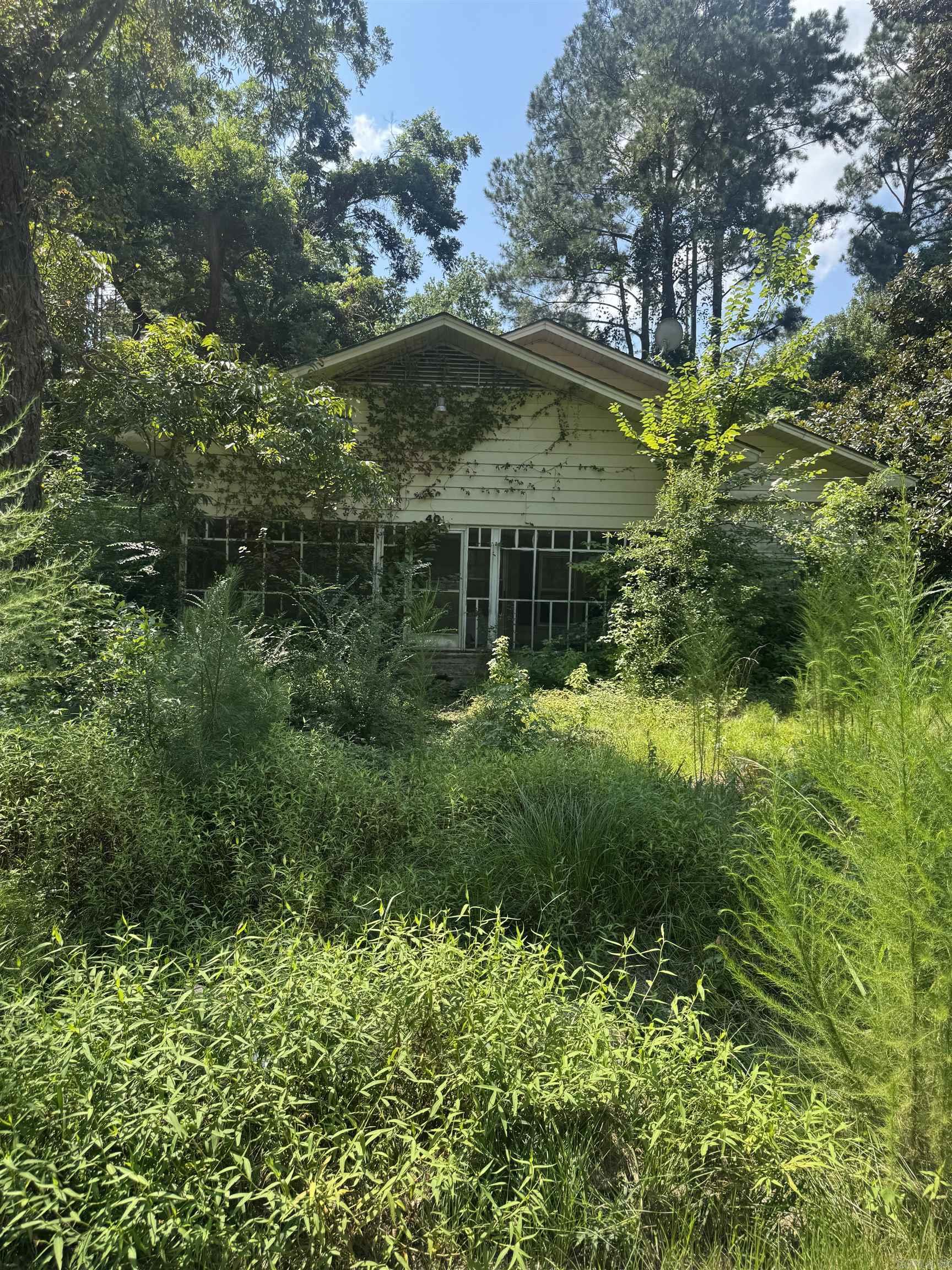 Secluded fixer- upper on 1.47 acres! Hidden Gen offers endless potential. perfect for investors or dreamers ready to renovated or rebuild. SOLD AS IS bring your vision and make it yours!