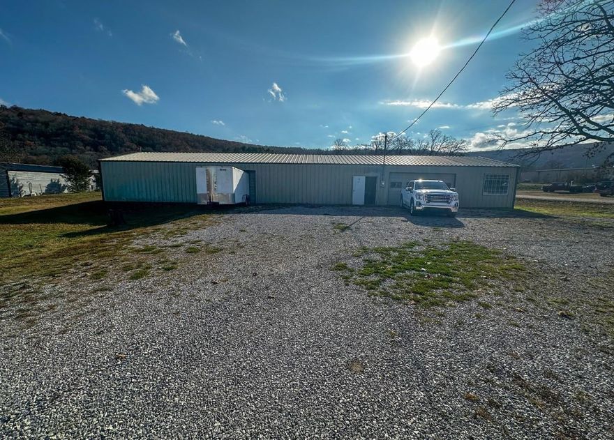 Prime Commercial Opportunity on West Main Street! Discover exceptional potential with this .93-acre corner lot located just outside the Mountain View city limits. Featuring a 3,000 sq ft metal building, this property is currently operating as a cabinet shop and is well-suited for a wide range of commercial, light industrial, or workshop uses. The building offers excellent functionality with a large garage door, convenient walk-through doors, and  office space. A paint booth and large exhaust fans will convey, providing valuable infrastructure for woodworking or similar trades. Additional perks include radiant floor heat and a half bath and a separate office space enhancing comfort and usability throughout the year. Situated on a high-visibility corner lot, this location offers outstanding exposure for your business with room for parking, expansion, or outdoor storage. Offered at $275,000.  Contact me today for more information or to schedule a viewing!