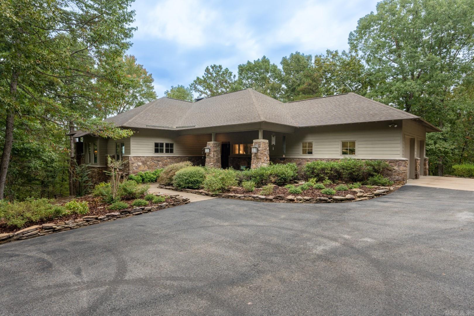 Discover your lakeside paradise at The Sanctuary! Nestled on over 23 acres of private lake front property, this stunning 4-bedroom, 3-bath lake house with breathtaking lake views offers a perfect blend of tranquility and luxury. With direct access to the water, you can enjoy all the activities provided by Greers Ferry Lake. Retreat down your private drive to the expansive lake acreage and home designed for comfort and style. Two gas fireplaces. Backup generator system (Generac). 30x50 insulated shop with power. Neighborhood boat ramp is accessible just a minute from your driveway. It's a unique opportunity to own your own slice of waterfront heaven.