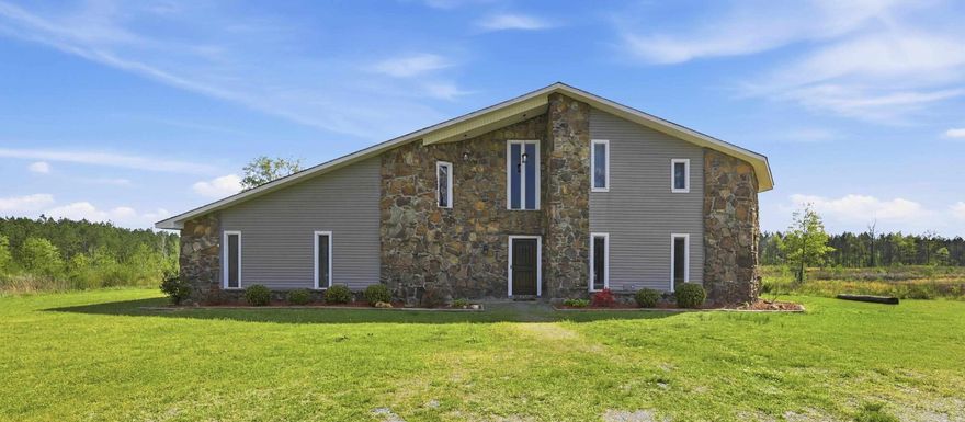 Experience unparalleled flexibility in this well-maintained property. The heart of the home features a chef's kitchen equipped with solid wood cabinetry, granite countertops, and a double convection wall oven. A generous breakfast bar and an expansive walk-in pantry. A cozy wood-burning fireplace anchors the living area, complemented by abundant storage throughout the home. The primary suite features an oversized ensuite bath, a substantial walk-in-closet, and a cozy fireplace for those cold winter nights. Productive spaces include a dedicated recording studio and plumbed office studio, both which easily transition into additional bedrooms or a private mother-in-law suite. The upstairs flex space is limited only by your imagination. Ideal for a home theater, gym, or creative hobby room. Outside the property is anchored by a massive 30x30 shop featuring dual lean-tos, providing exceptional storage for equipment, vehicles, or a substantial home workshop. Experience the ultimate multi-functional retreat where professional workspace meets residential luxury-all in one exceptional property. Call to schedule your private showing today!