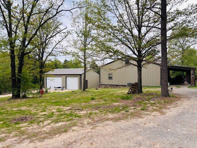 Charming 3-bedroom, 2-bath steel-framed home nestled on nearly 4 partially wooded, unrestricted acres at the end of a quiet dead-end road—just minutes from Clinton! This unique property features an open layout with a large kitchen, a split-bedroom design, and oversized bedrooms, each with its own private exterior door. Both bathrooms are spacious and well-appointed. The home and detached 3-car garage are both built with durable steel framing for added strength and longevity. Step out onto the back deck and enjoy peaceful views of the yard, a meandering creek, and even a couple of neat rock formations on the property! Upstairs, the unfinished attic with a half-bath offers incredible potential for additional living space. With privacy, natural beauty, and convenience to Greers Ferry Lake (less than 10 minutes away!), this home is a rare find full of opportunity. No restrictions—bring your vision!