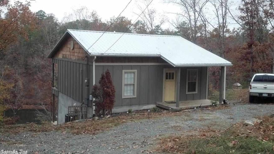 WANT TO GET AWAY FROM IT ALL, BUT BE CLOSE ENOUGH TO CITY...THIS IS IT! Bring your clothes & move into this 2 BR-2BA stylishly fully-furnished home at Lake Norrell. Sit on your tiled patio or your upper deck & enjoy your 120 feet of beautiful lake frontage & all the trees. This home was built & decorated by a Builder with stainless steel appliances, open-floor plan, hardwood & tile floors. The home is very well insulated. There is even a build-in grill on the upper deck.