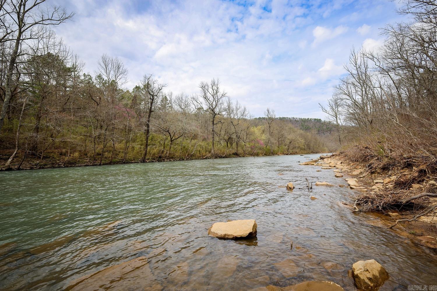 The 80-acre recreational use, river view property is 2.4 miles down Angora Mountain Road, by the famous railroad ghost town Arlberg, off HWY 110 in Stone County. The property features mature timber, with level to steep terrain, two year-round creeks bordering both sides of the property which feed into the Little Red River. A breathtaking 40' waterfall is located in the center of the property, along with an abundance of wildlife, including whitetail deer and turkey. The Middle Fork Little Red River is known for its pristine, clear water and trout fishing. Sit back and enjoy the ambient sounds of the river and the stunning views of the Ozark Mountains. No utilities available. Recreational use property or for off-grid living.