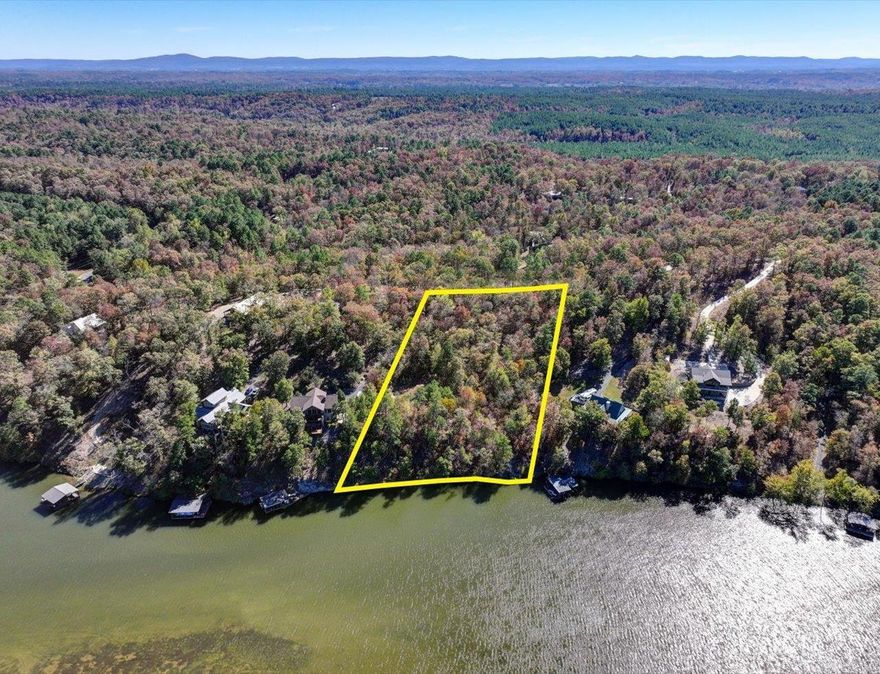 With 213 front feet along Lake Hamilton's shoreline, this 2.1 Acre MOL tract could be a gorgeous setting for a new home! Owner has cleared an area for a home site which would have a phenomenal lake view and already installed a 1,000 Gallon Septic tank. There's currently stairs down to a Boardwalk along part of the shoreline and the property has previously been approved for a two stall boat dock. Owner ended up moving to Saline County before plans were finished. Build your dream home or even build several homes on this property. There's a 560 sq ft metal storage building in place closer to the street. This Lakefront side of 276 Woodview will be subject to new survey. It is still recorded as one lot. Taxes for land only are undetermined at this time. Great Lakefront land with acreage for folks that want more privacy. This part of Woodview Lanes lakefront area is slightly West of Lake Hamilton's' main channel. The 'Sandbar' and '501 Lakeside'  are both nearby and up the main channel.  Sign on the property and feel welcome to walk the property.  The South side of Woodview Lane with another 2.1 MOL acres and a home is listed separately, MLS #25006877.