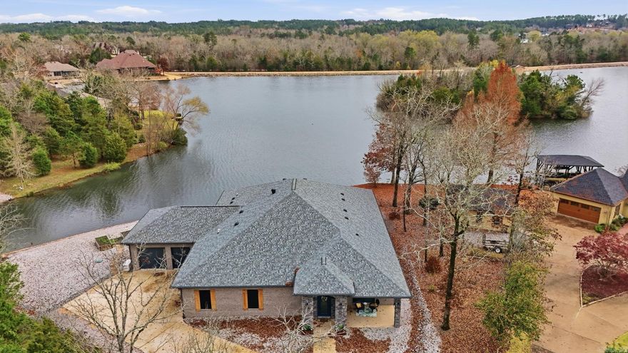 Experience luxury lakefront living on Lake Sophia in this stunning custom-built 2022 home featuring 4 bedrooms, 4.5 bathrooms, a dedicated media room, and 3,292 sq ft of beautifully designed living space. This modern waterfront home offers an open-concept floor plan with breathtaking panoramic lake views, expansive windows, and upscale finishes throughout. The gourmet chef’s kitchen is a true showpiece with premium Viking appliances, custom cabinetry, oversized island, and designer details—perfect for entertaining. The spacious living and dining areas are filled with natural light and showcase incredible water views from nearly every angle. The luxurious primary suite offers a private retreat with spa-inspired finishes, dual walk-in closets, and a beautifully appointed bath. Additional features include a safe room, buried propane tank, whole-house generator, extensive storage, and 2 oversized garages with space for vehicles and golf carts. Enjoy 178 feet of seawall frontage, outdoor living spaces, and the perfect blend of modern efficiency, privacy, and resort-style lakefront living.  High end luxury custom craftmanship and stunning lake views in one package!