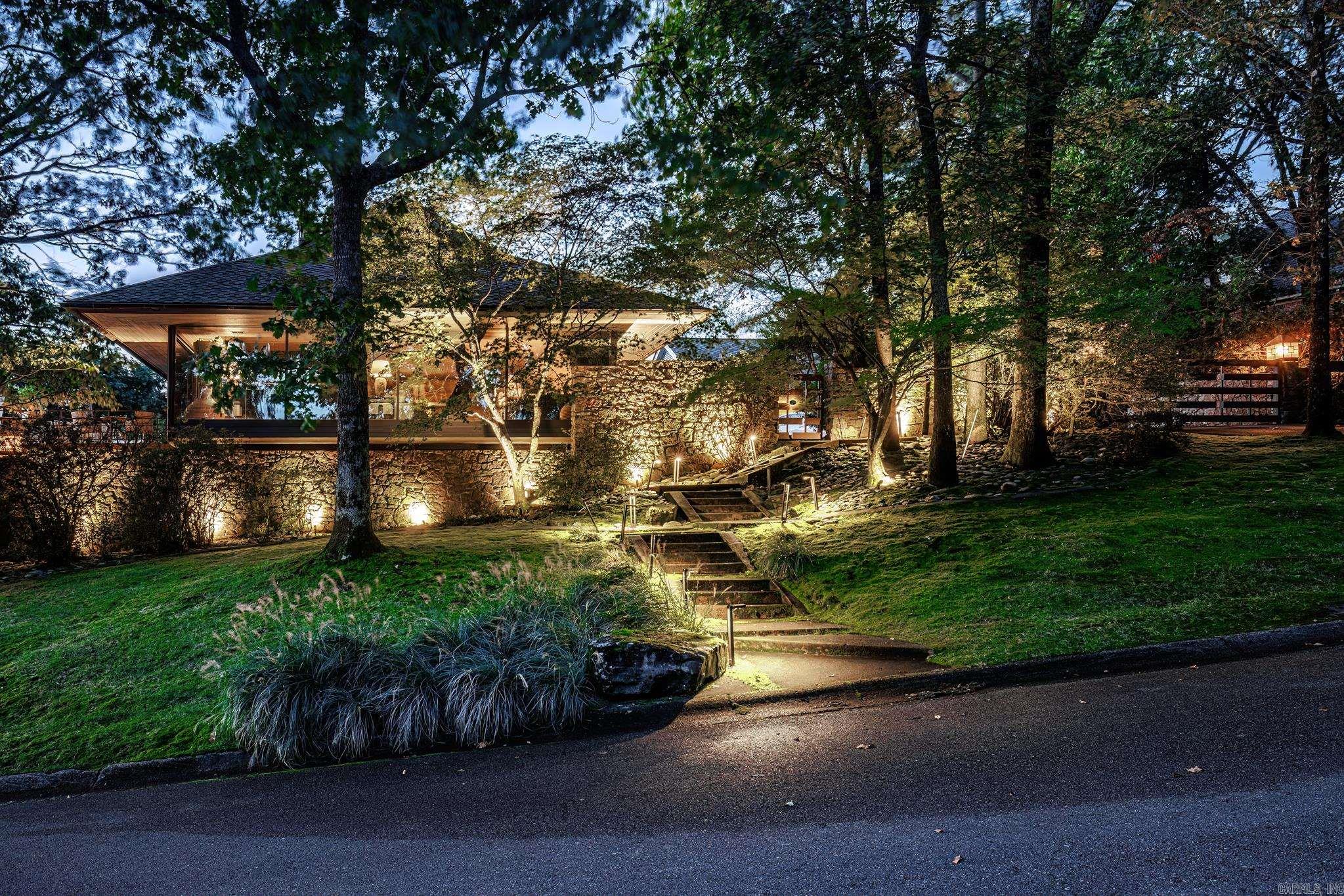 Modern Cromwell Masterpiece with Breathtaking Arkansas River Views. Perched on a coveted lot overlooking the Arkansas River, this modern Cromwell-designed estate is a true architectural masterpiece. Floor-to-ceiling windows frame panoramic views, including the iconic Big Dam Bridge, while flooding the interior with natural light. Designed for both luxury and functionality, this home boasts a chefās kitchen with top-of-the-line appliances, sleek custom cabinetry, and premium finishes throughout. The seamless indoor-outdoor living experience is elevated by endless decks, a tranquil koi pond, a saltwater pool, and a cascading waterfallāperfect for relaxation or entertaining. A gated driveway ensures privacy, while a home generator provides peace of mind. Surrounded by extensive landscaping and lush outdoor spaces, this home offers a rare blend of sophistication and serenity in one of the most sought-after locations. Donāt miss this extraordinary opportunity to own a true riverside retreat. AGENTS SEE REMARKS
